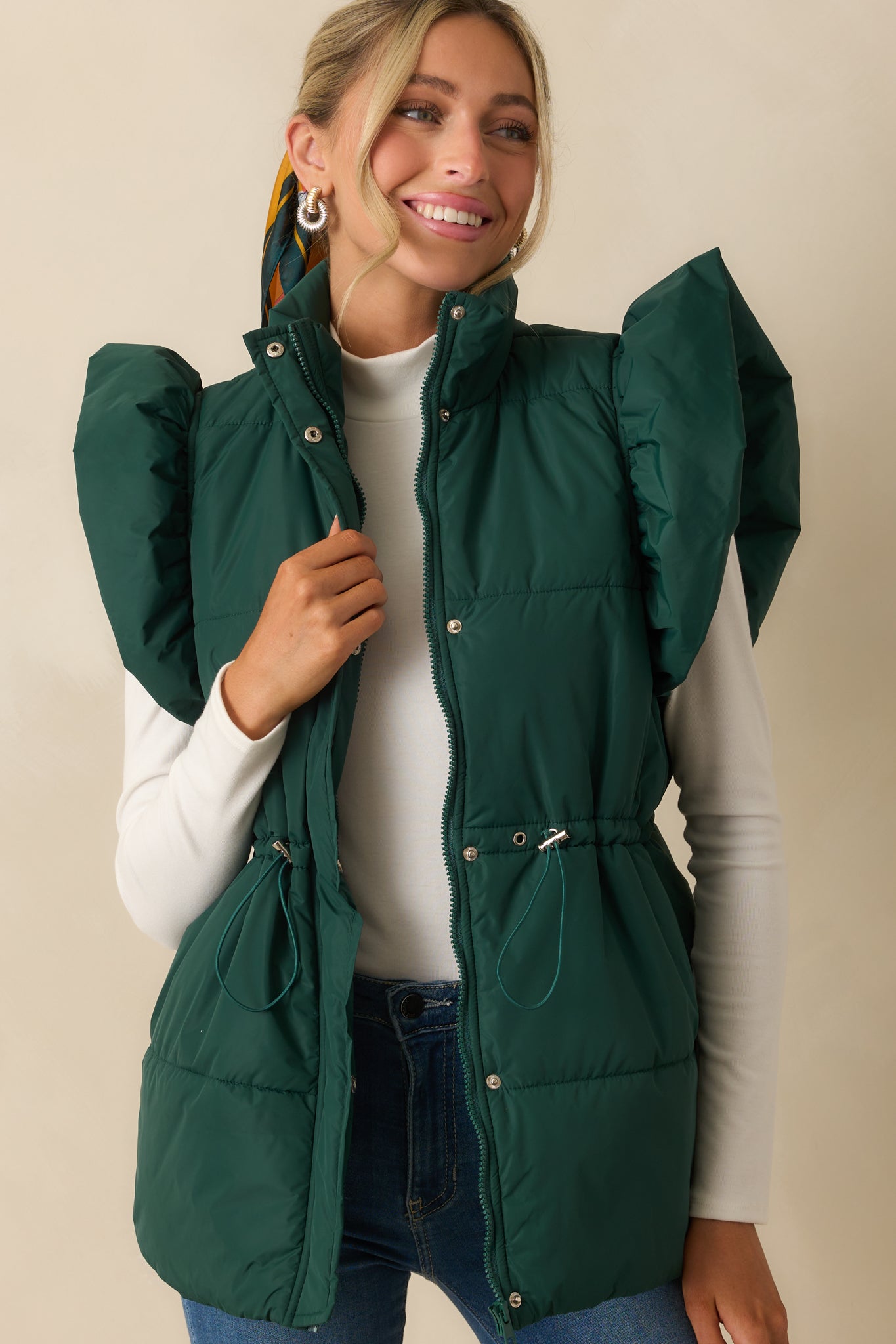 Forest green vest showing hip pocket placement and clean stitching.