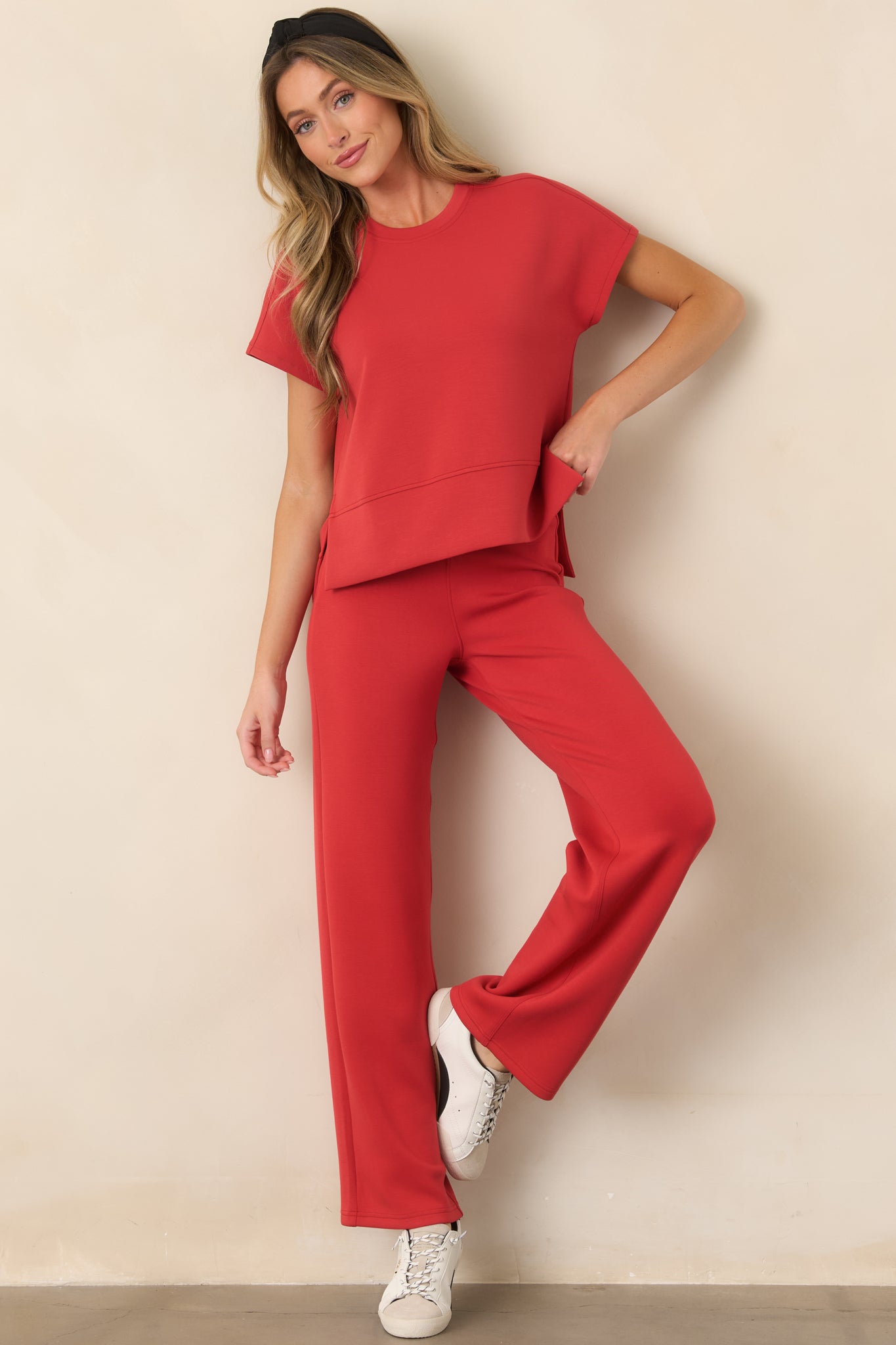 Four-way stretch top featuring a classic crew neckline, short sleeves, and a high-low hem with side slits for easy movement.