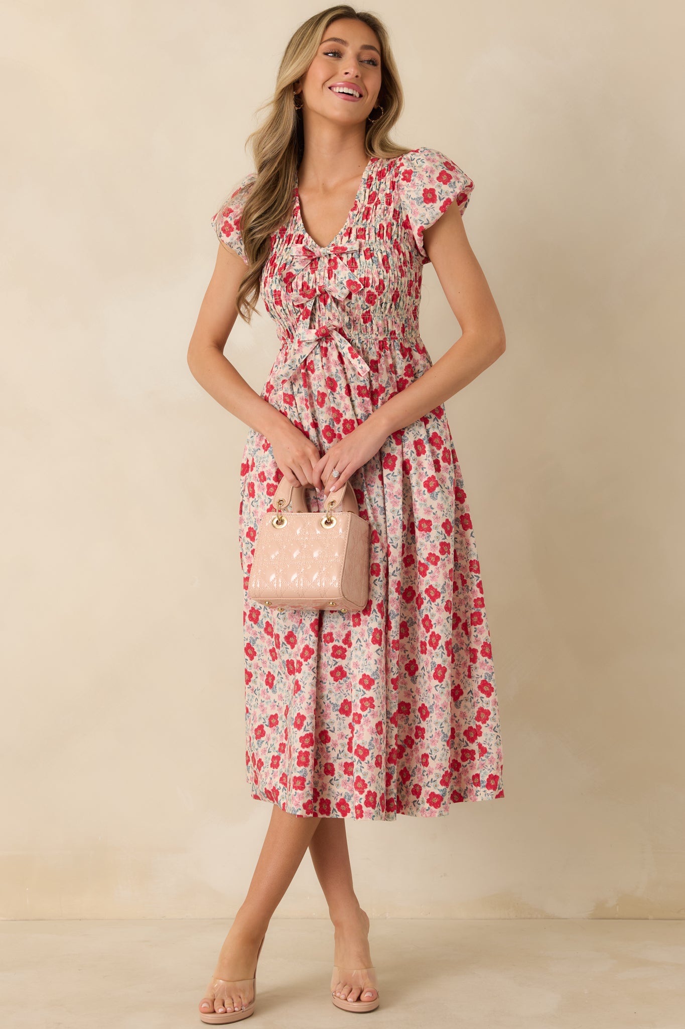 Front-facing angle emphasizing the fitted smocked waist and soft drape of the floral skirt.