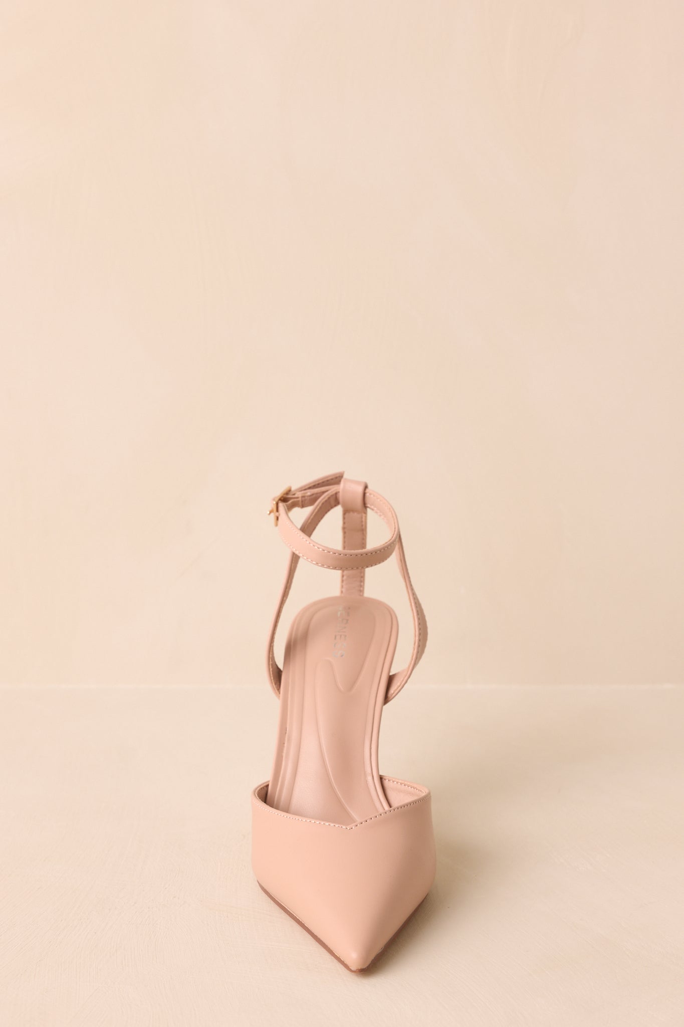 Front angle showing tapered pointed toe and smooth faux leather texture.