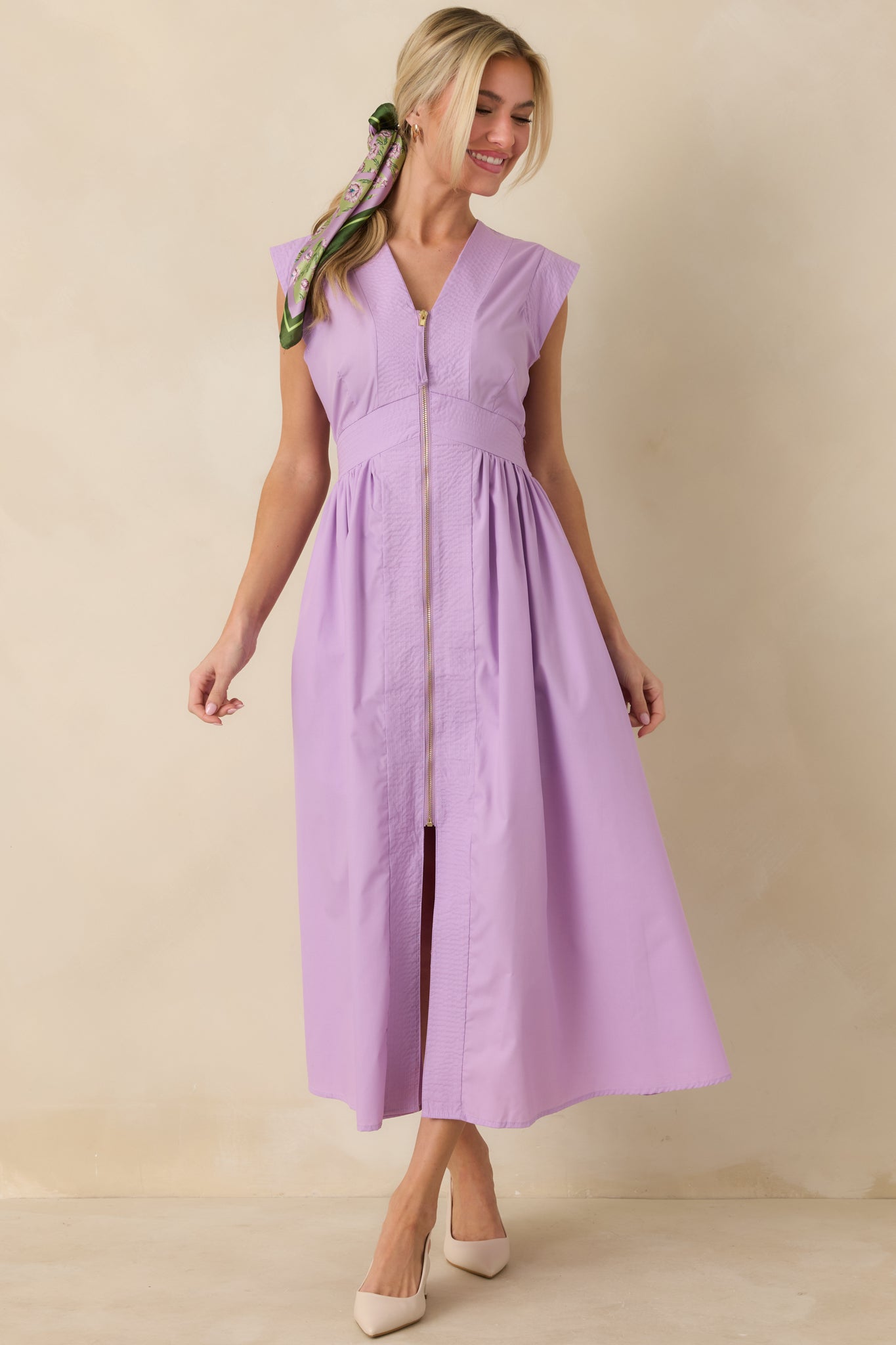 Full body front angle showcasing the structured V-neck bodice and the smooth transition into a lightly flared midi skirt.