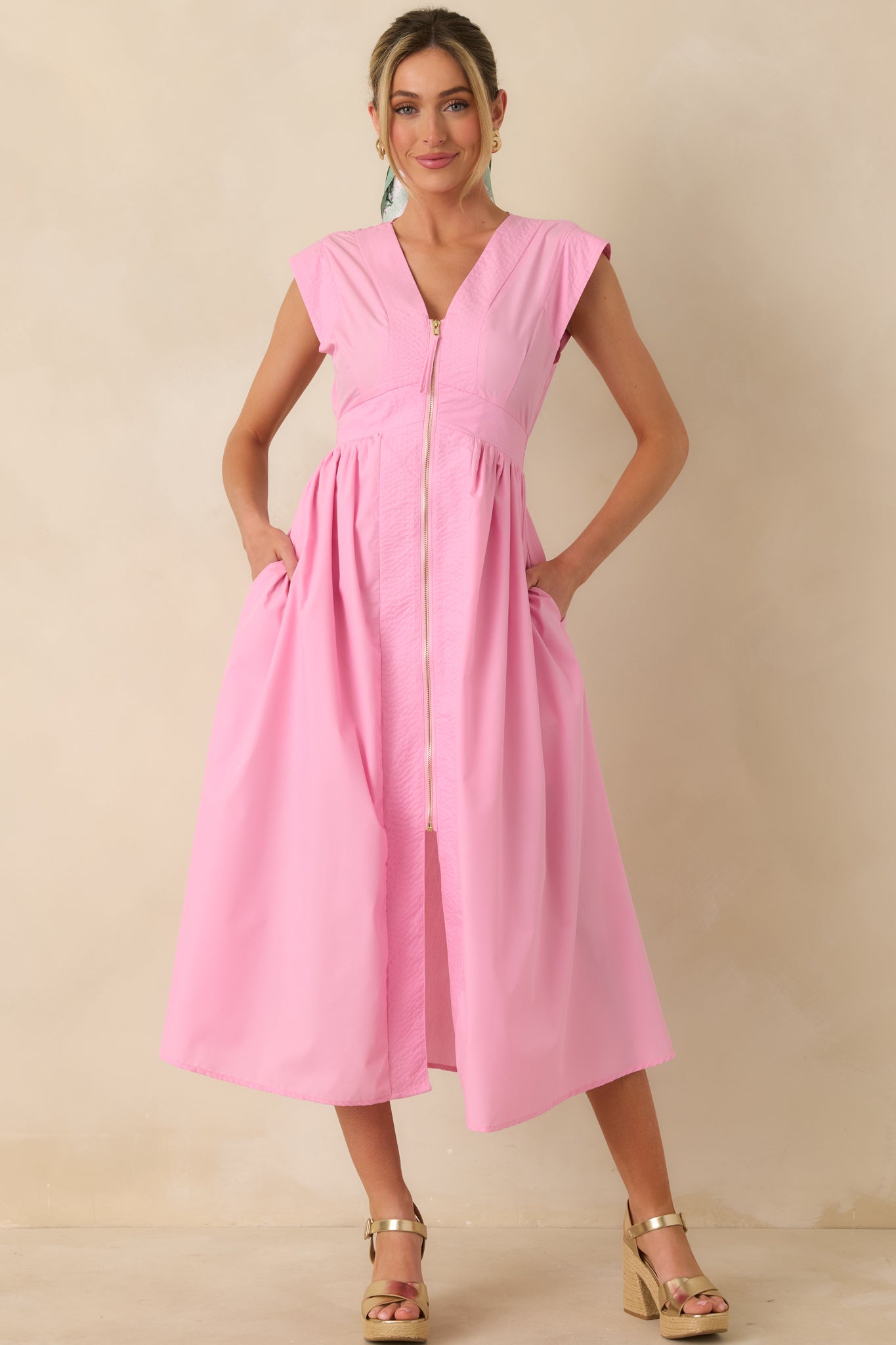 Full body front angle showcasing the structured V-neck bodice and the smooth transition into a lightly gathered midi-length skirt.