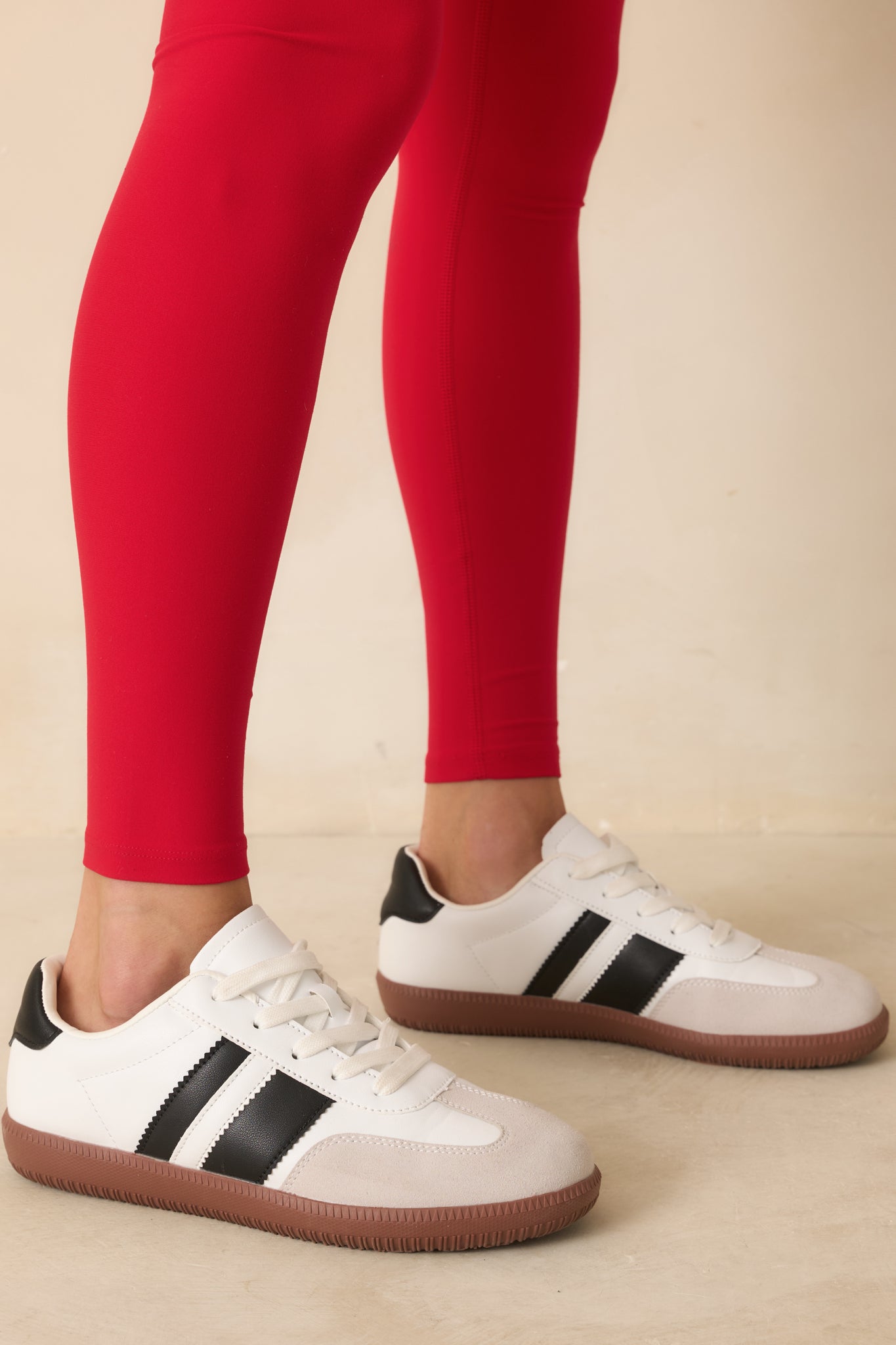 Front angle displaying the toe shape, panel stitching, and black contrast stripes along the sides.