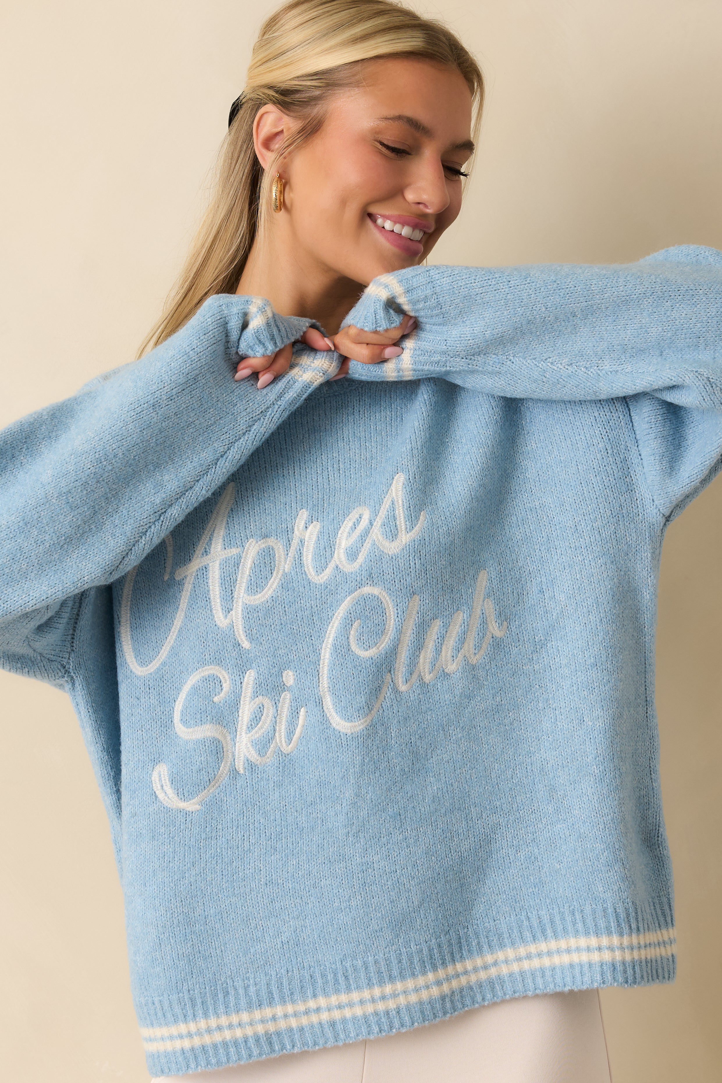 Front crop highlighting relaxed fit and dropped shoulder seam of the powder blue knit.