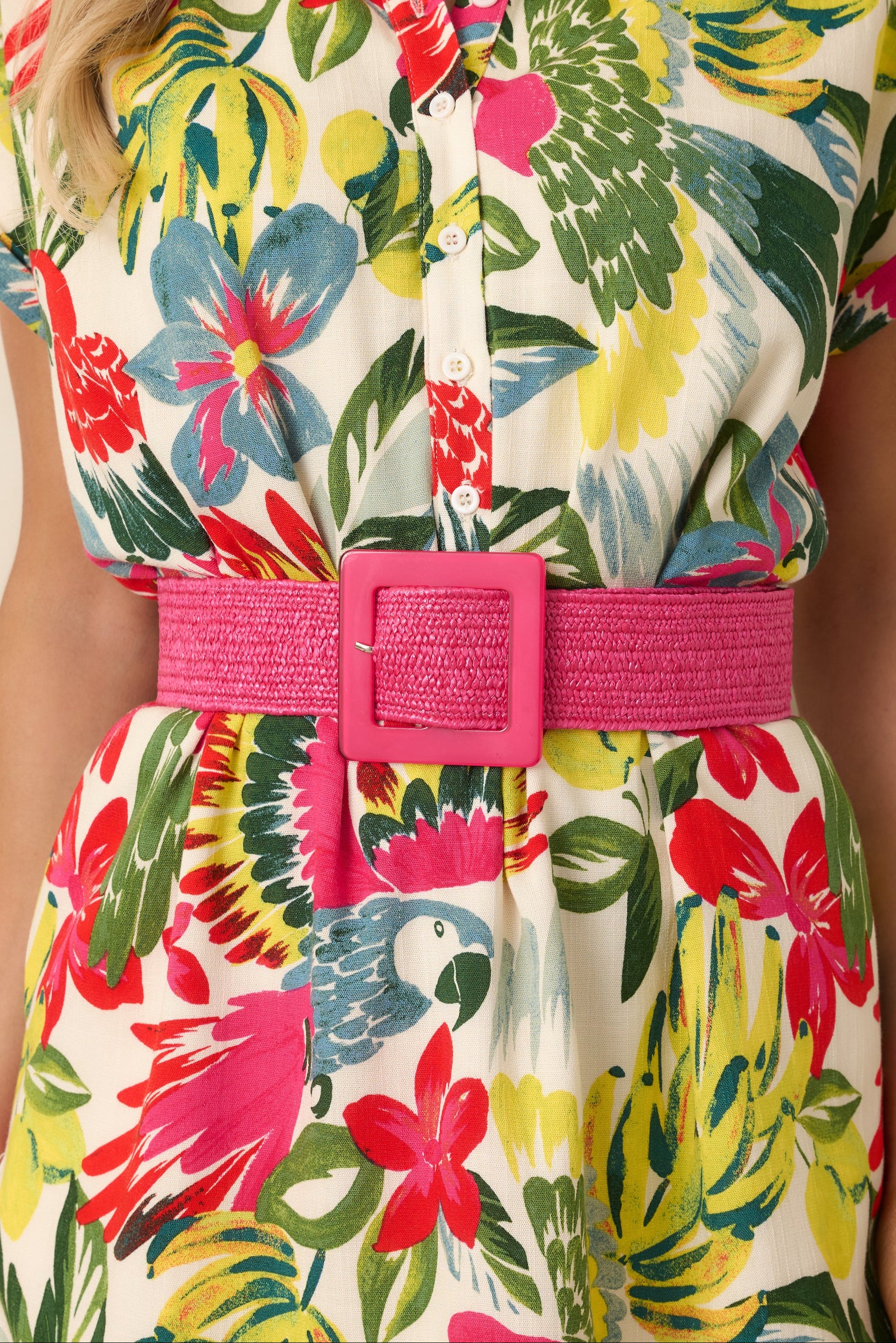 Front cropped detail of pink elastic belt emphasizing adjustable buckle and smooth weave