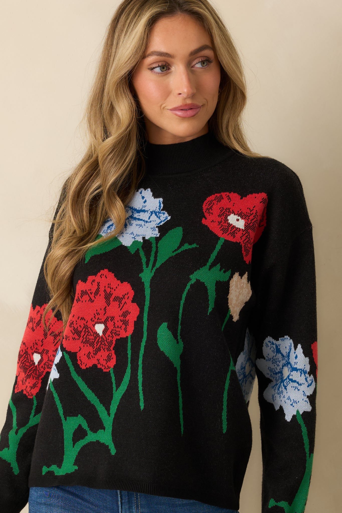 Front-focused detail showing the ribbed hem and vibrant floral motifs across the knit fabric.