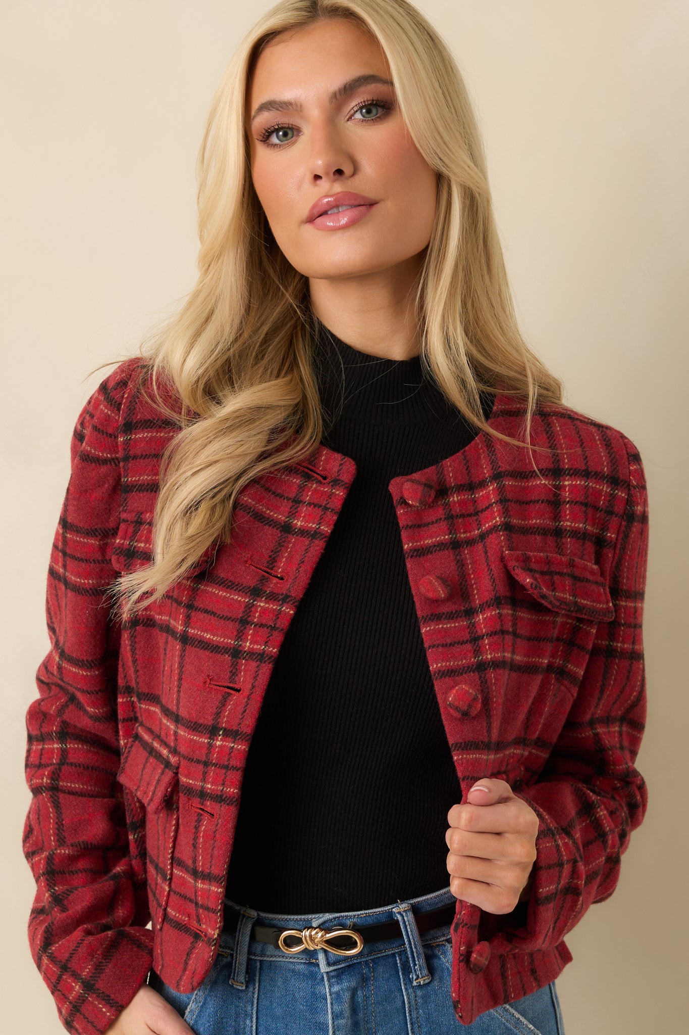 Front detail of round neckline and textured fabric on cropped plaid jacket.