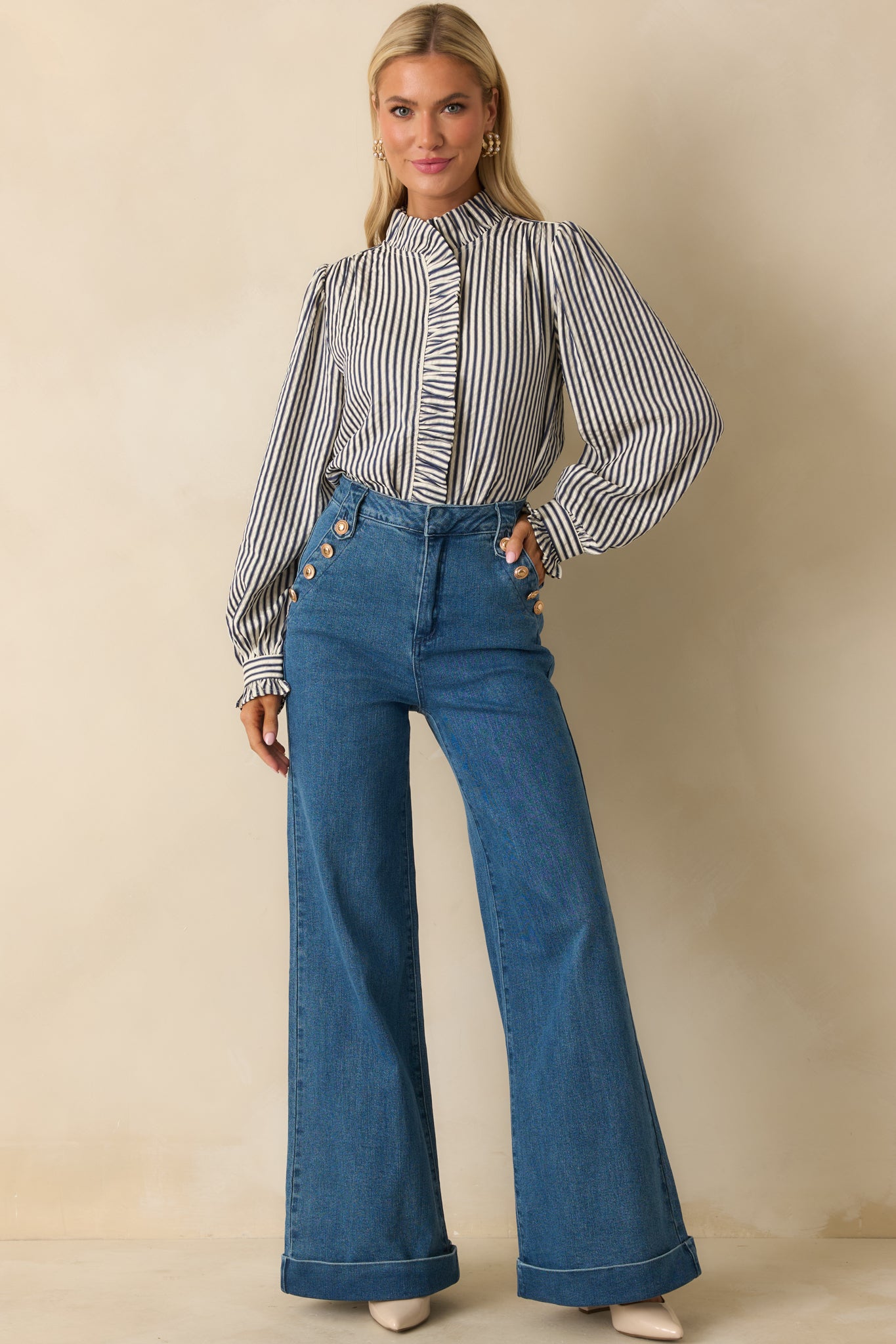 Front-facing blouse featuring a mock neckline and button-up closure with ruffled placket.