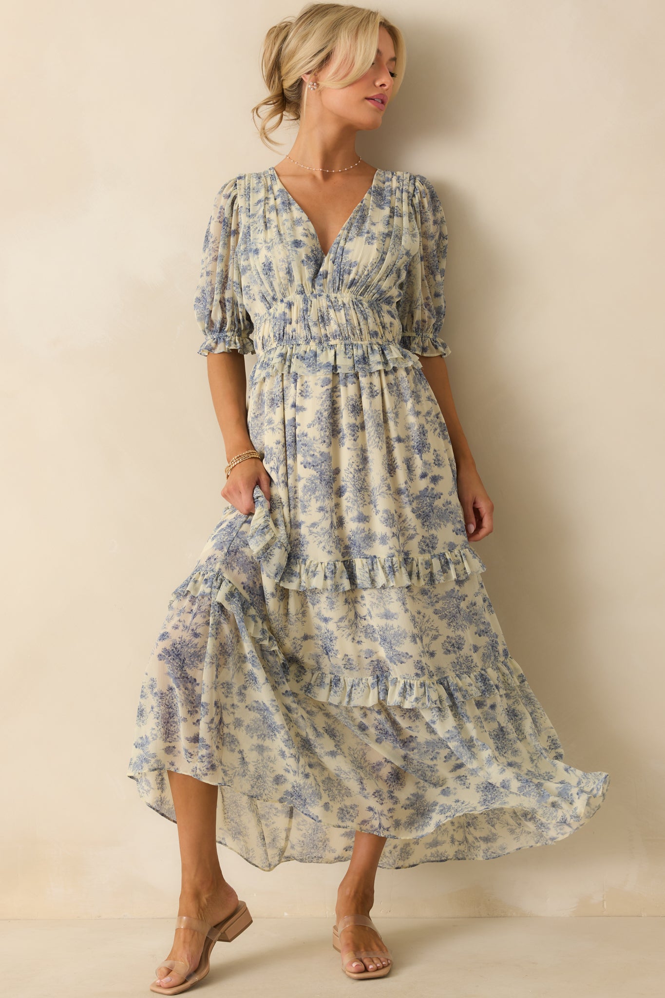 Front-facing shot of the tiered blue dress highlighting the ruffled trim details and flowing maxi length.