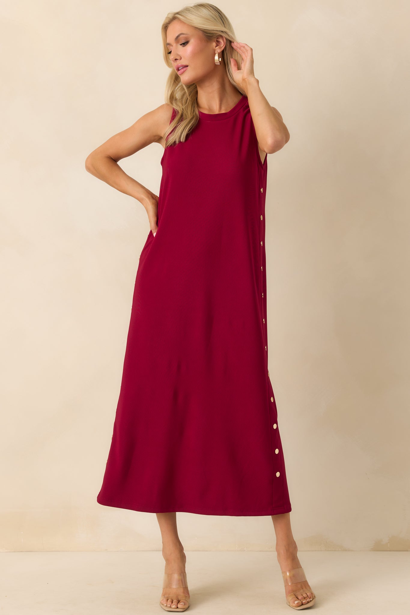 Front-facing full length image highlighting the relaxed fit and decorative gold buttons along the sides.