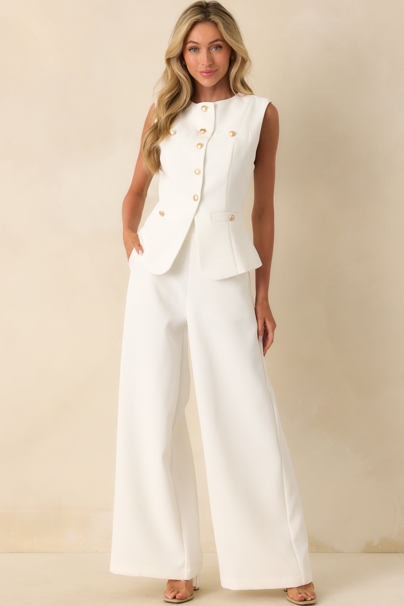 Front-facing full length image highlighting the wide leg silhouette and functional side pockets of the white pants.