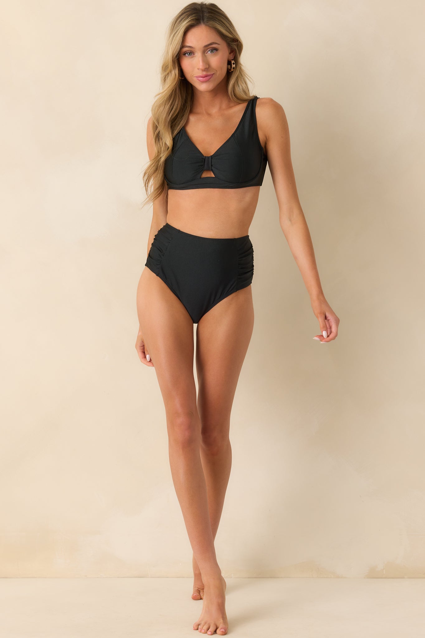 Front-facing full body image showcasing the smooth fit of the high rise silhouette and subtle side ruching.