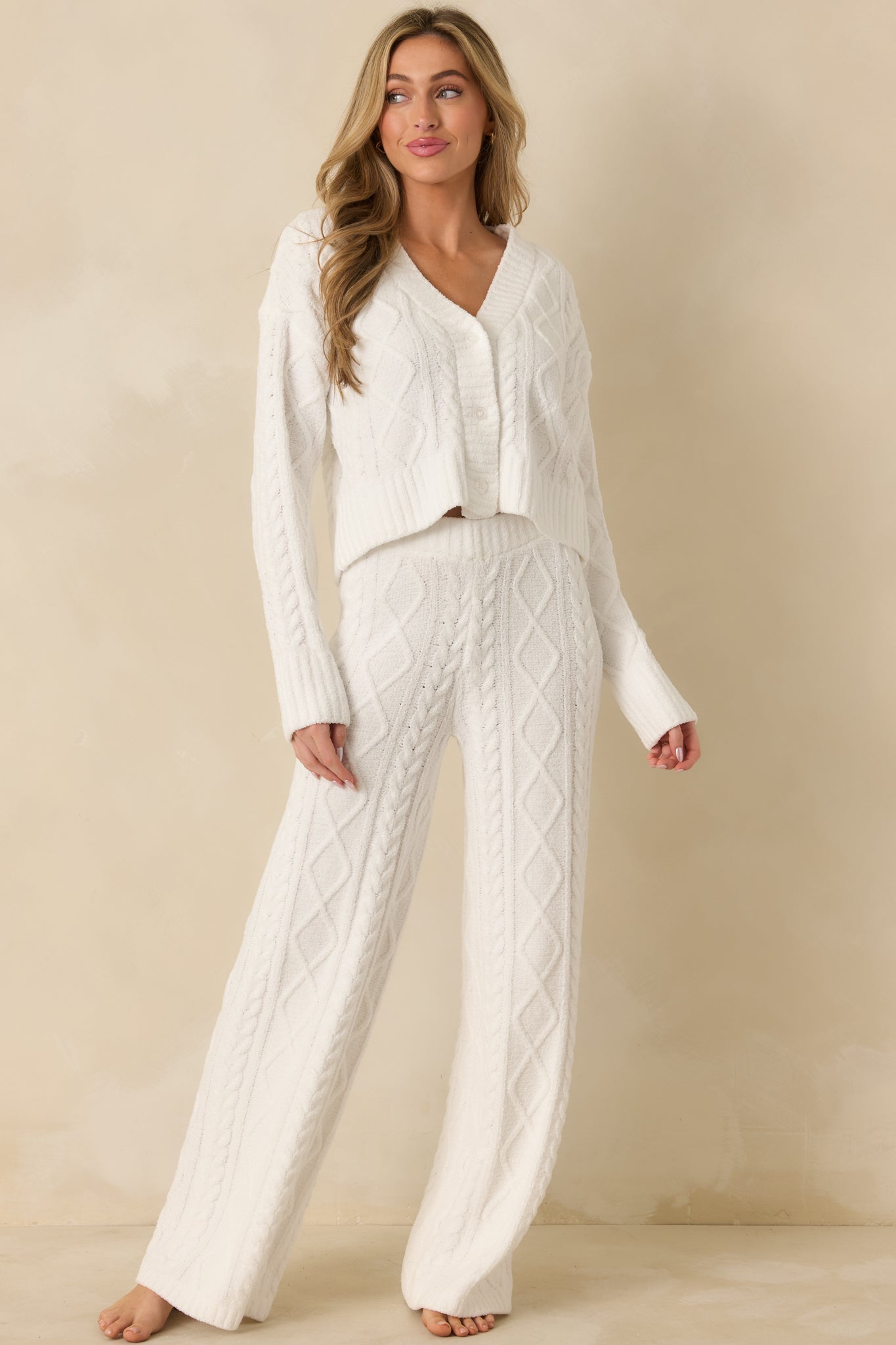 Front-facing ivory cardigan showing long sleeves, ribbed cuffs and hem, and casual drape.