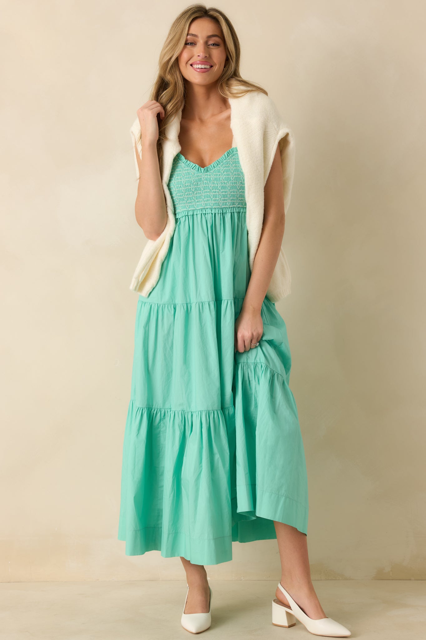 Front-facing mint green midi dress highlighting the fully smocked embroidered bodice and soft flowing hem.