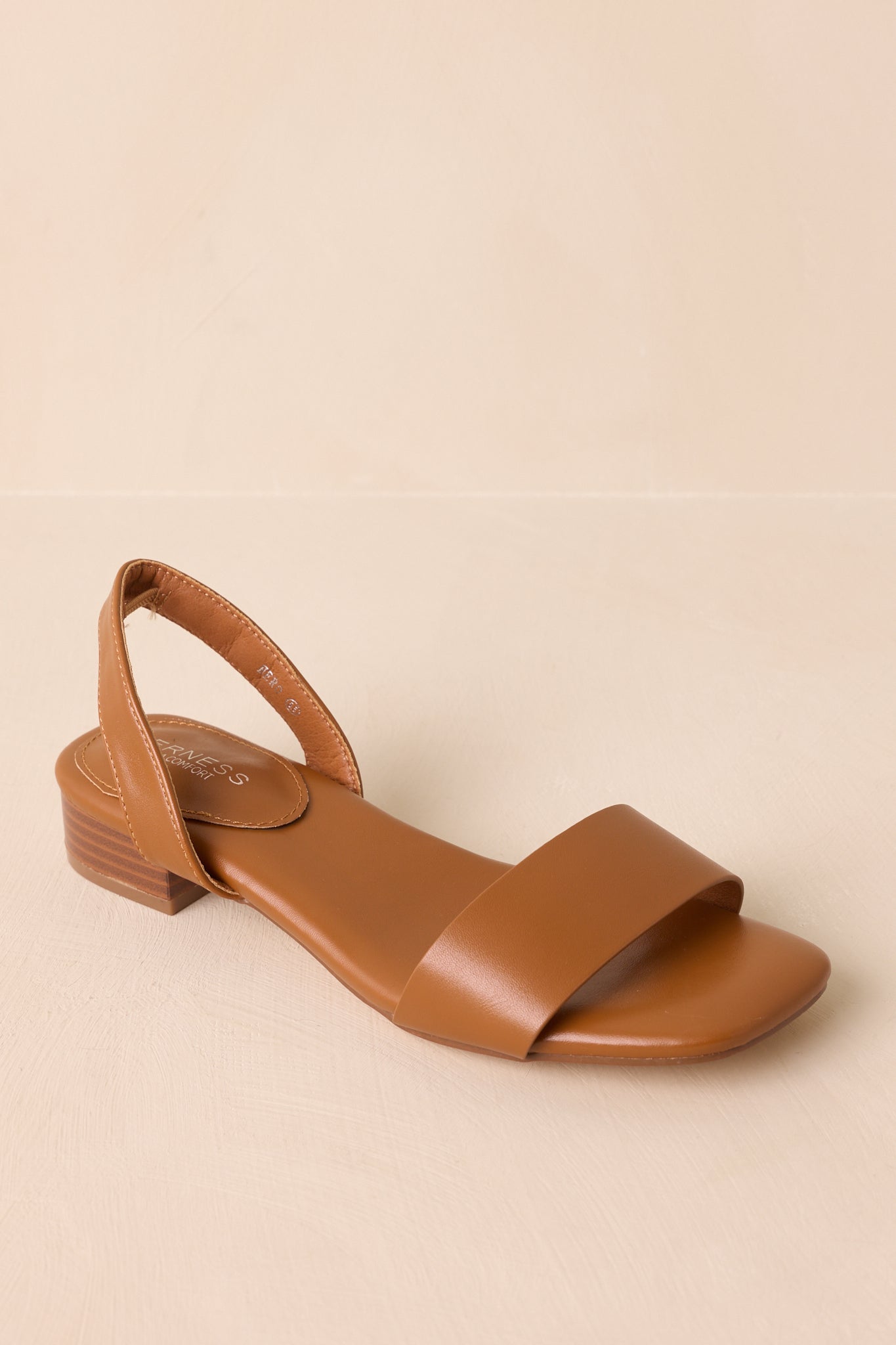 Front-facing view emphasizing toe strap and soft cushioned footbed of caramel sandal.