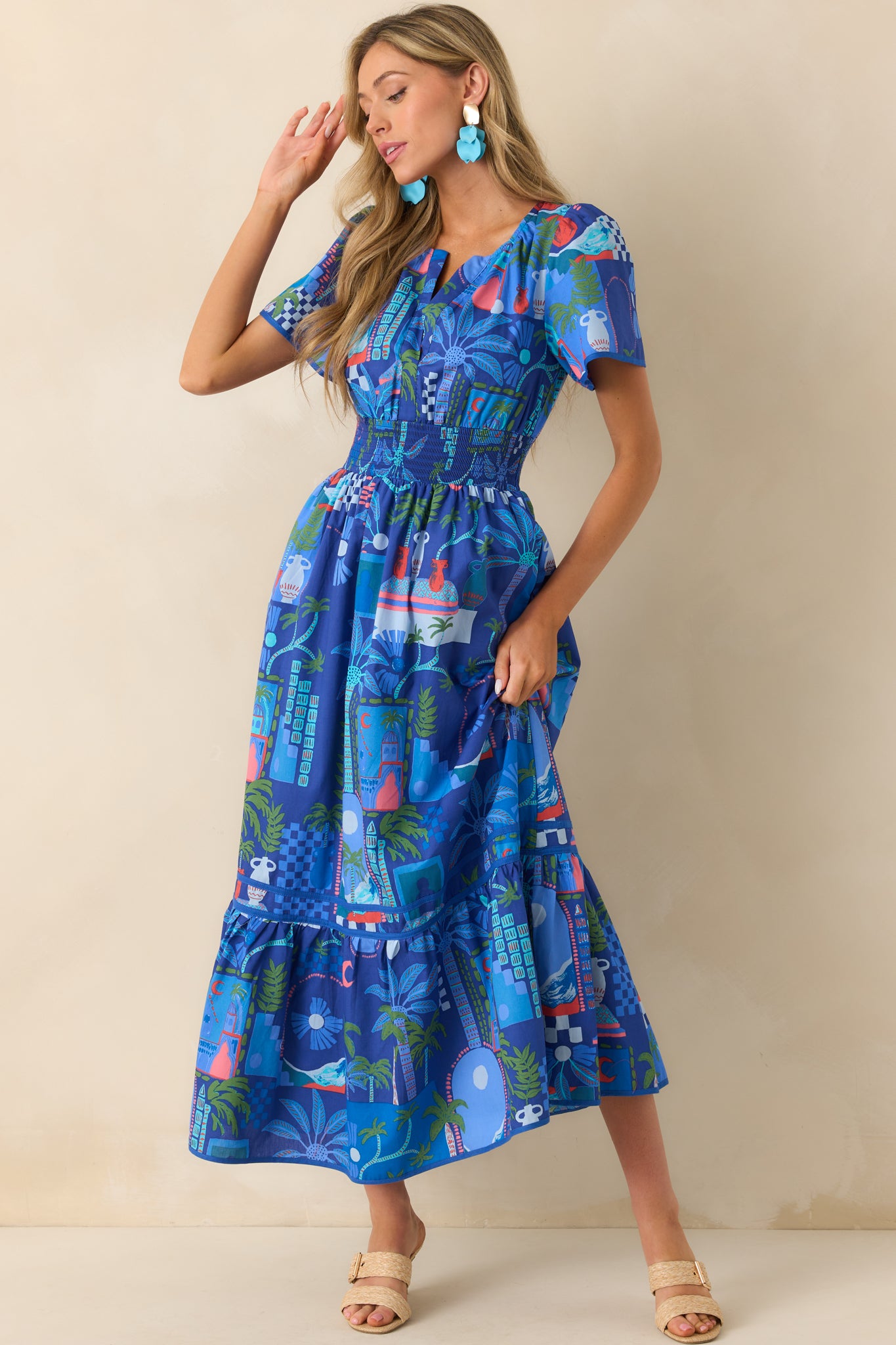 Front-facing full body view of the maxi dress showcasing the cobalt blue symmetrical print and notch v-neckline.