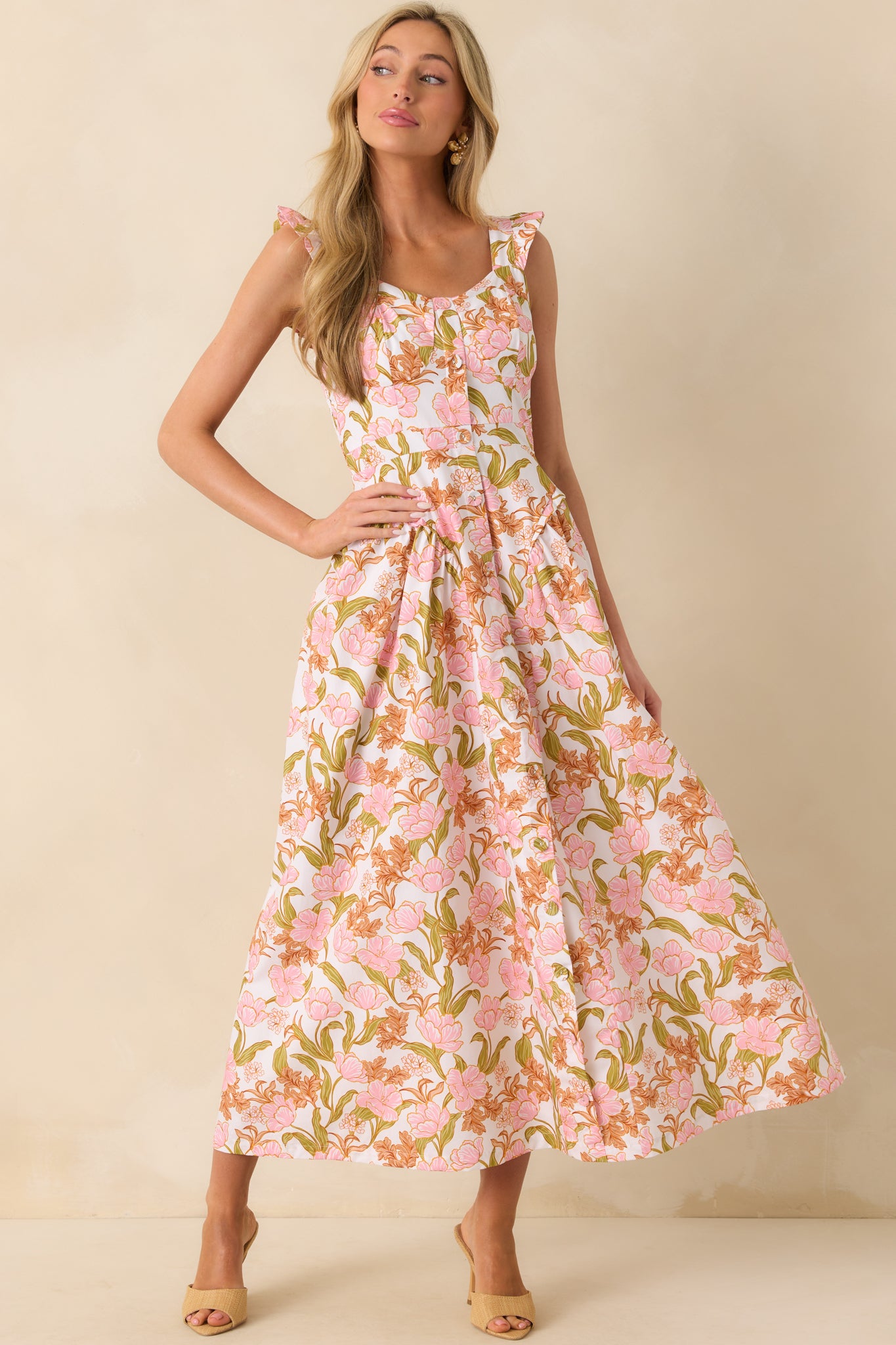 Front-facing full body view of the maxi dress featuring a pink floral print, scoop neckline, and fitted bodice.