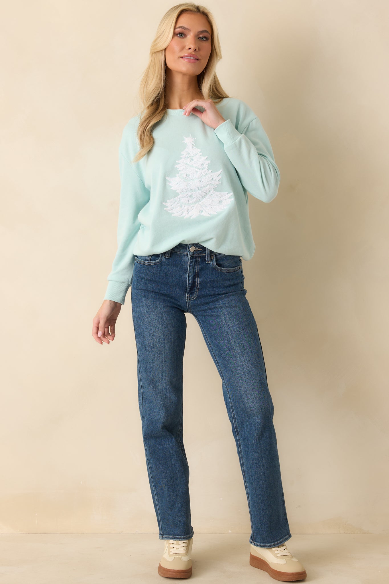 Front-facing full view highlighting the crew neckline, soft knit fabric, and festive tree design.