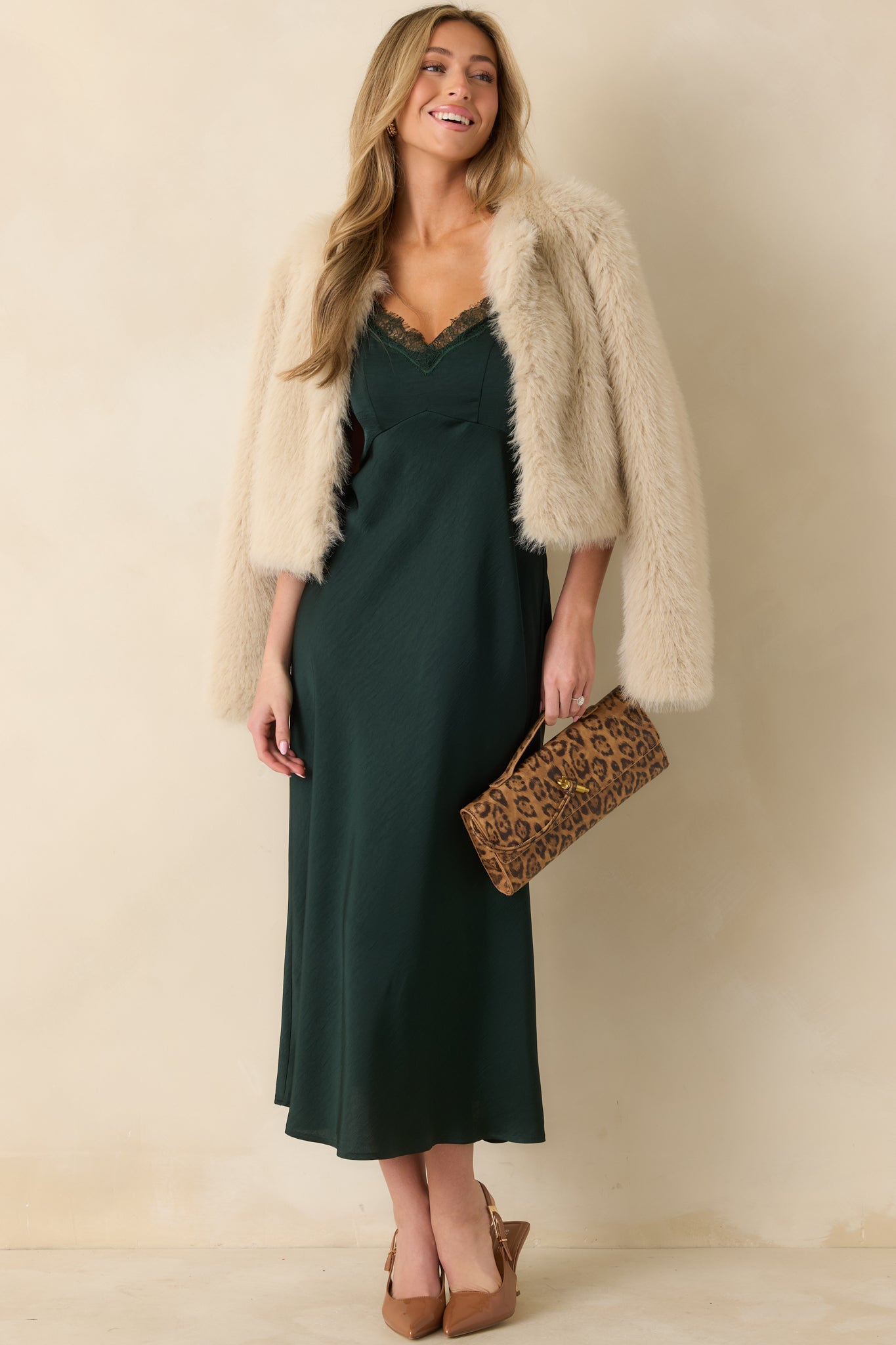 Front view of green slip-style midi dress with lace-trimmed V-neckline and adjustable spaghetti straps.