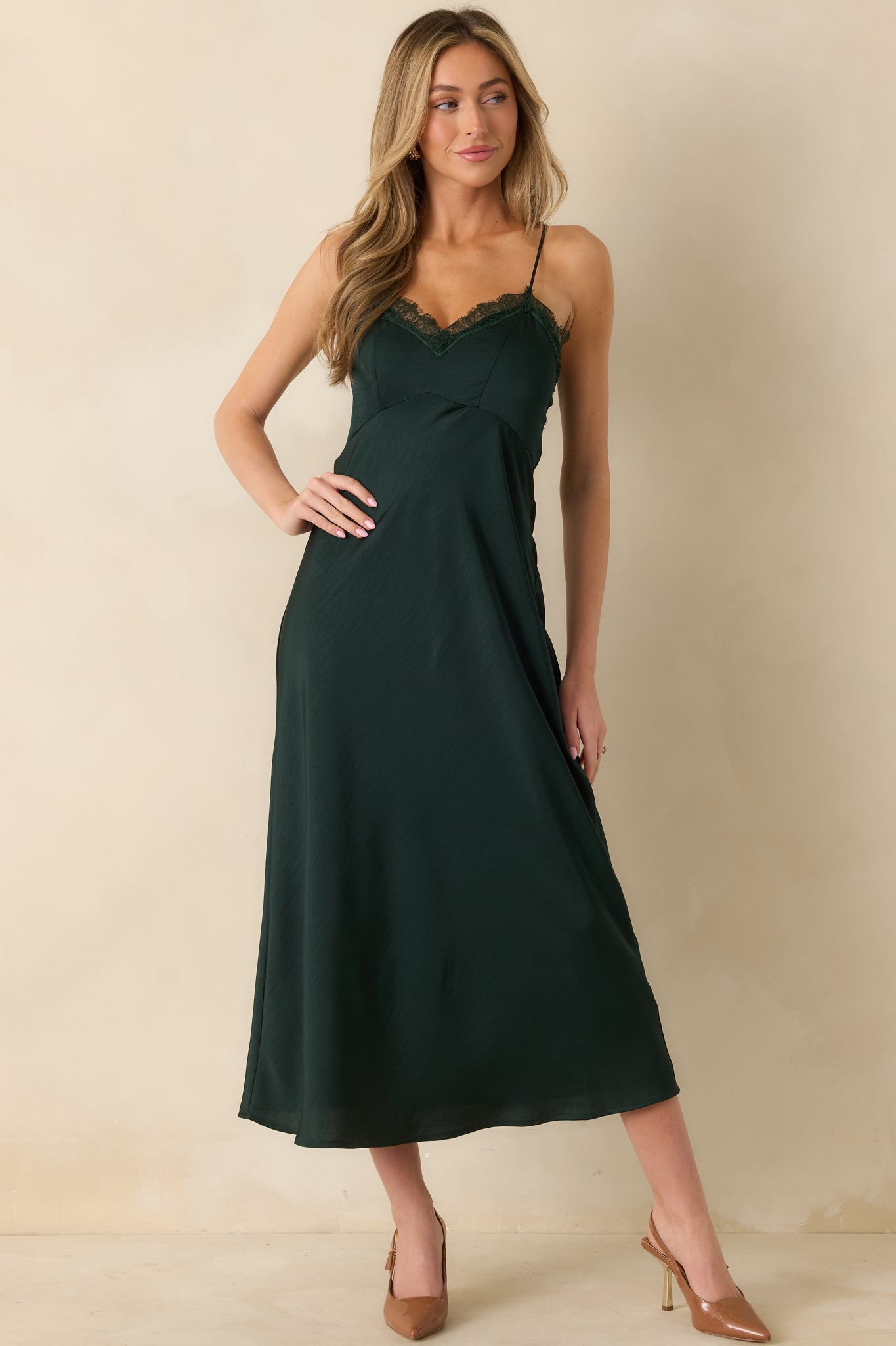 Posed front shot highlighting lace trim along V-neckline and elegant fall of the fabric.