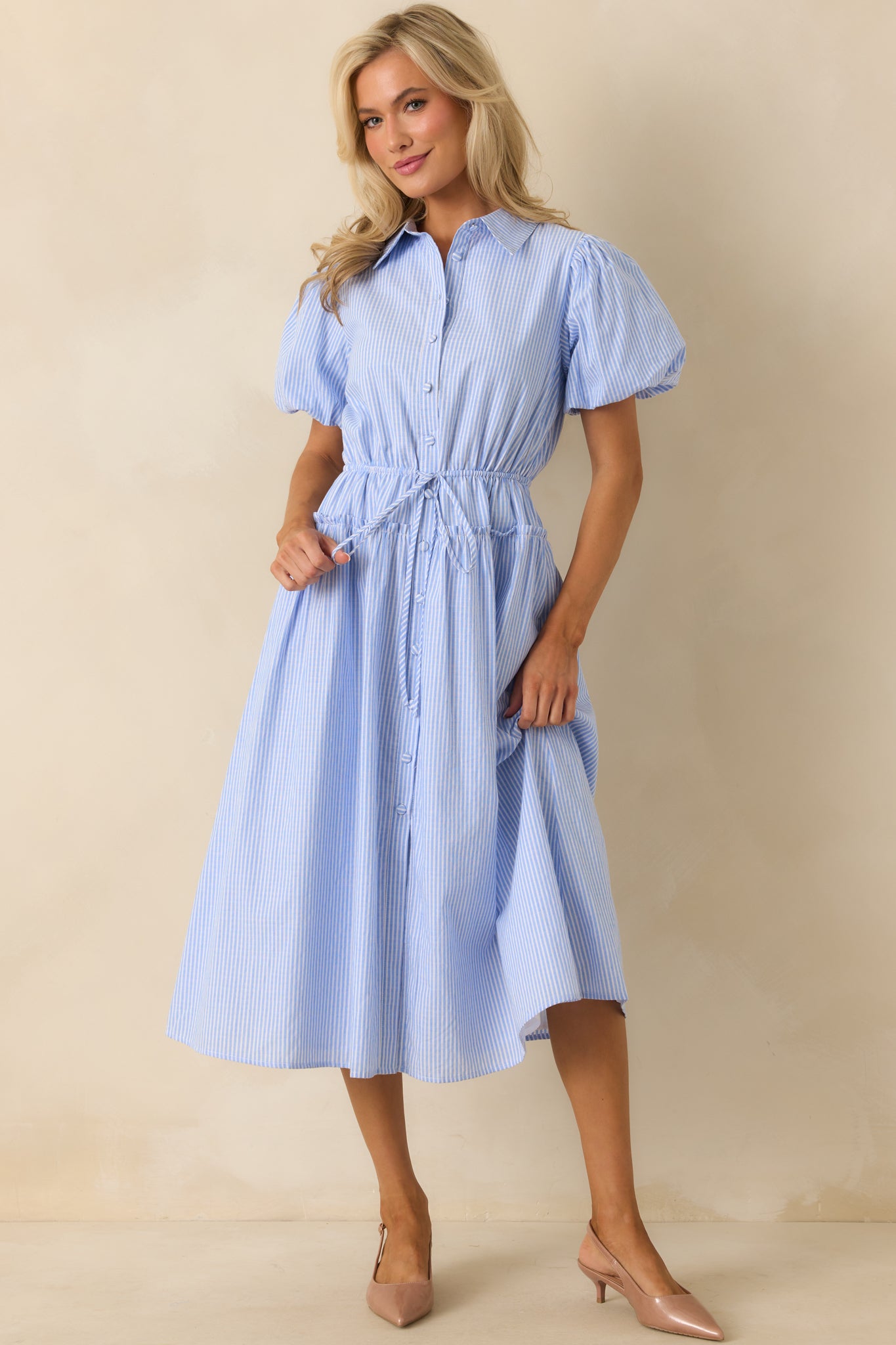 Front view showing the functional pockets in use and the relaxed silhouette of the maxi dress.
