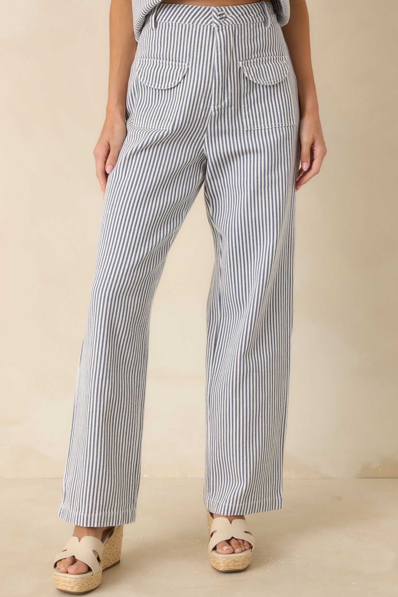 Close look at the front patch pockets with flap detailing and striped woven fabric.