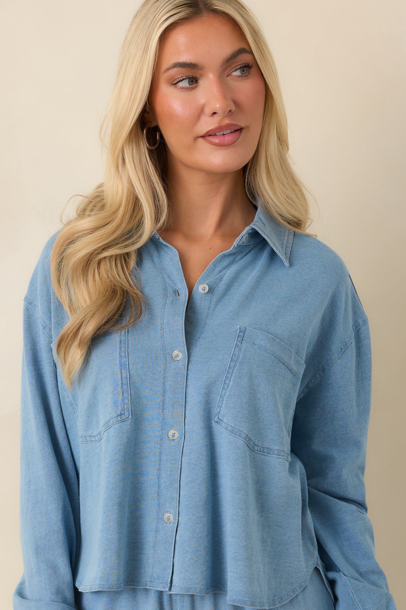 Close-up highlighting the front patch pockets and relaxed fabric construction of the top.
