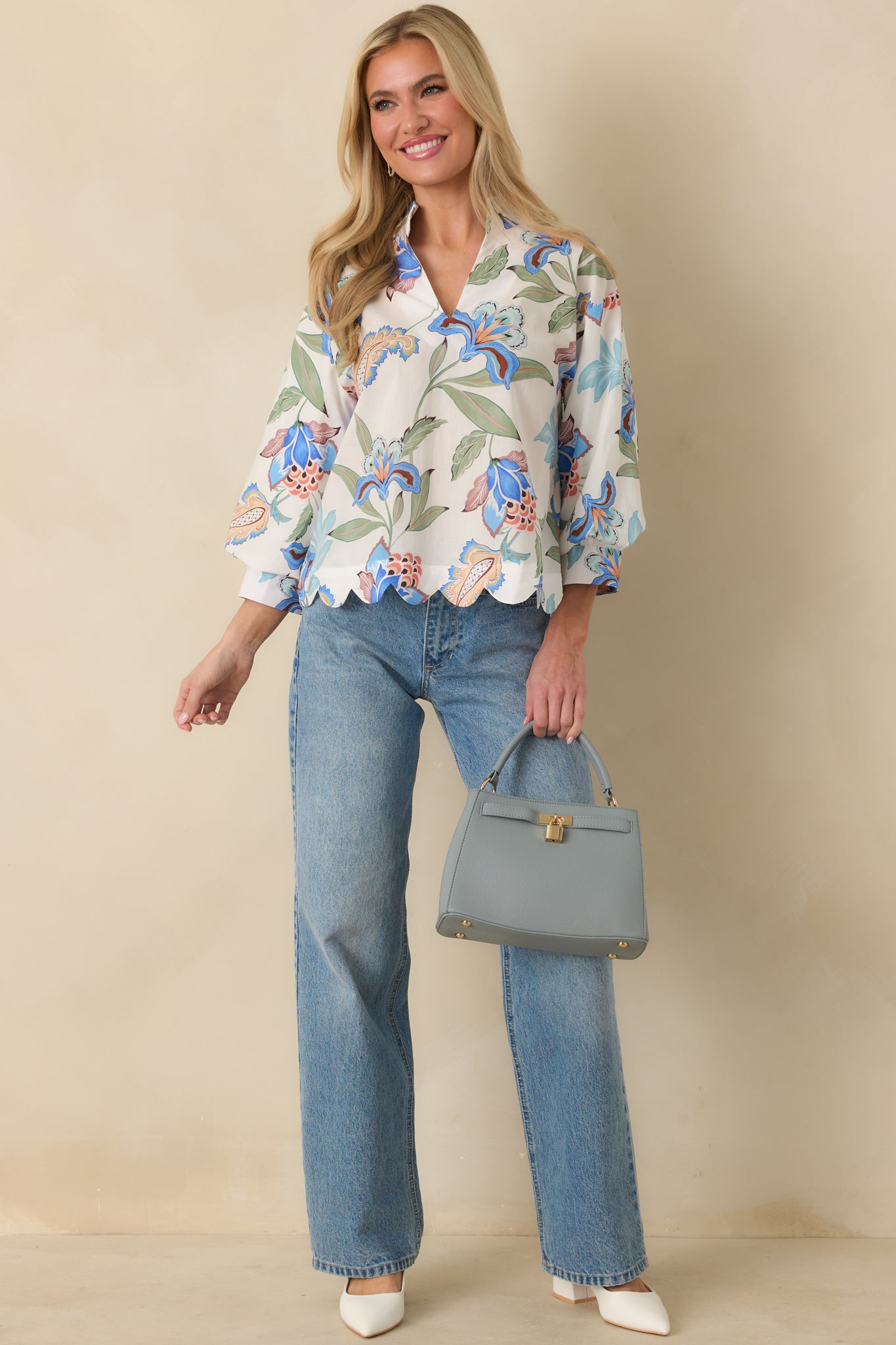 Angled front perspective highlighting the buttoned sleeve cuffs and lightweight cotton fabric of the top.