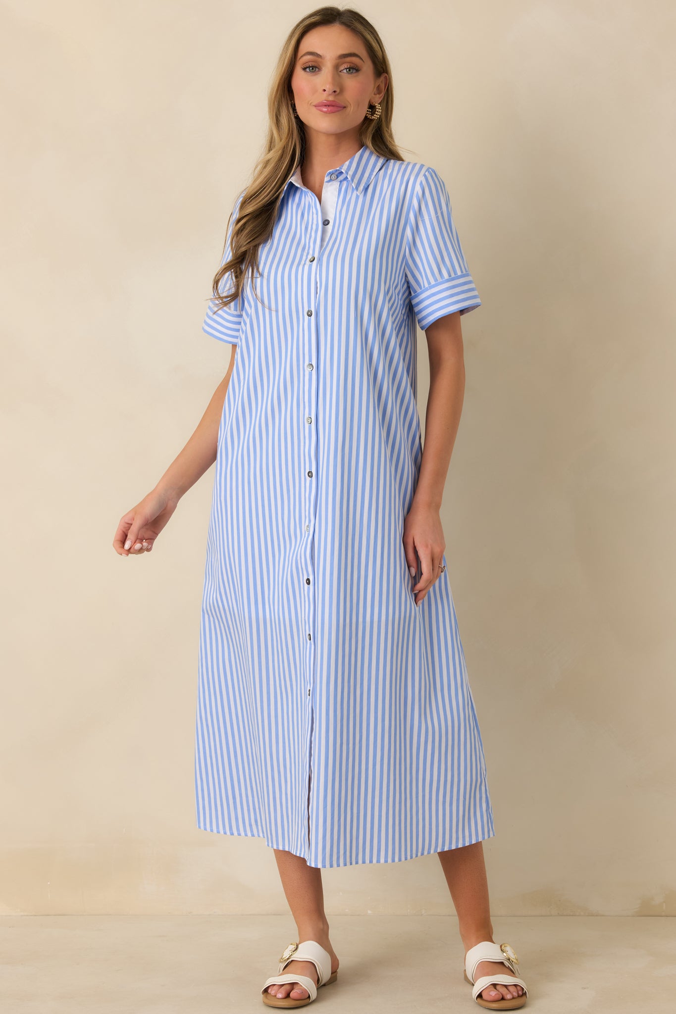 Angled front perspective highlighting the relaxed A-line silhouette and flowing maxi-length hem of the striped shirt dress.