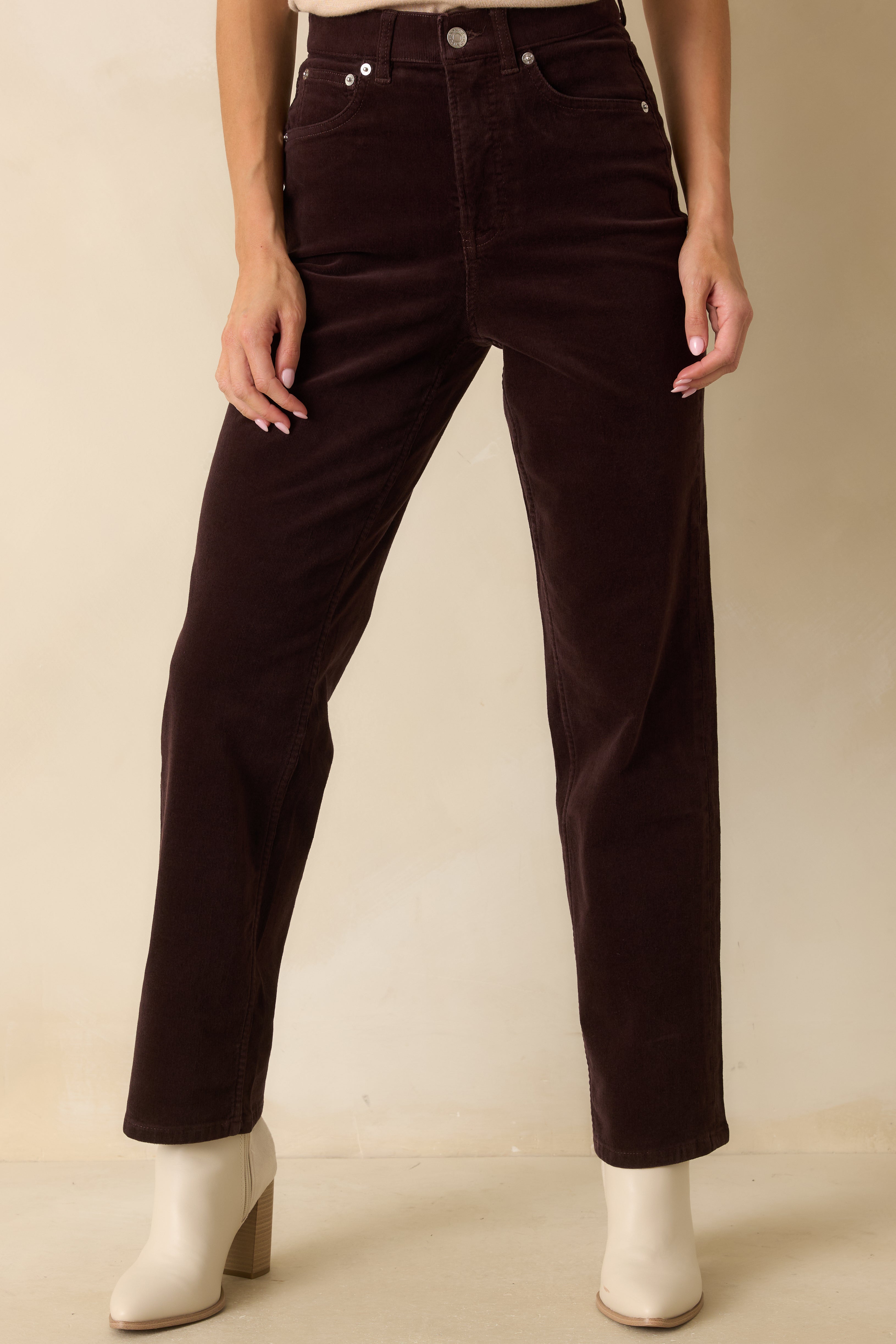 Detail of front pockets, button closure, and soft stretch fabric in truffle brown.
