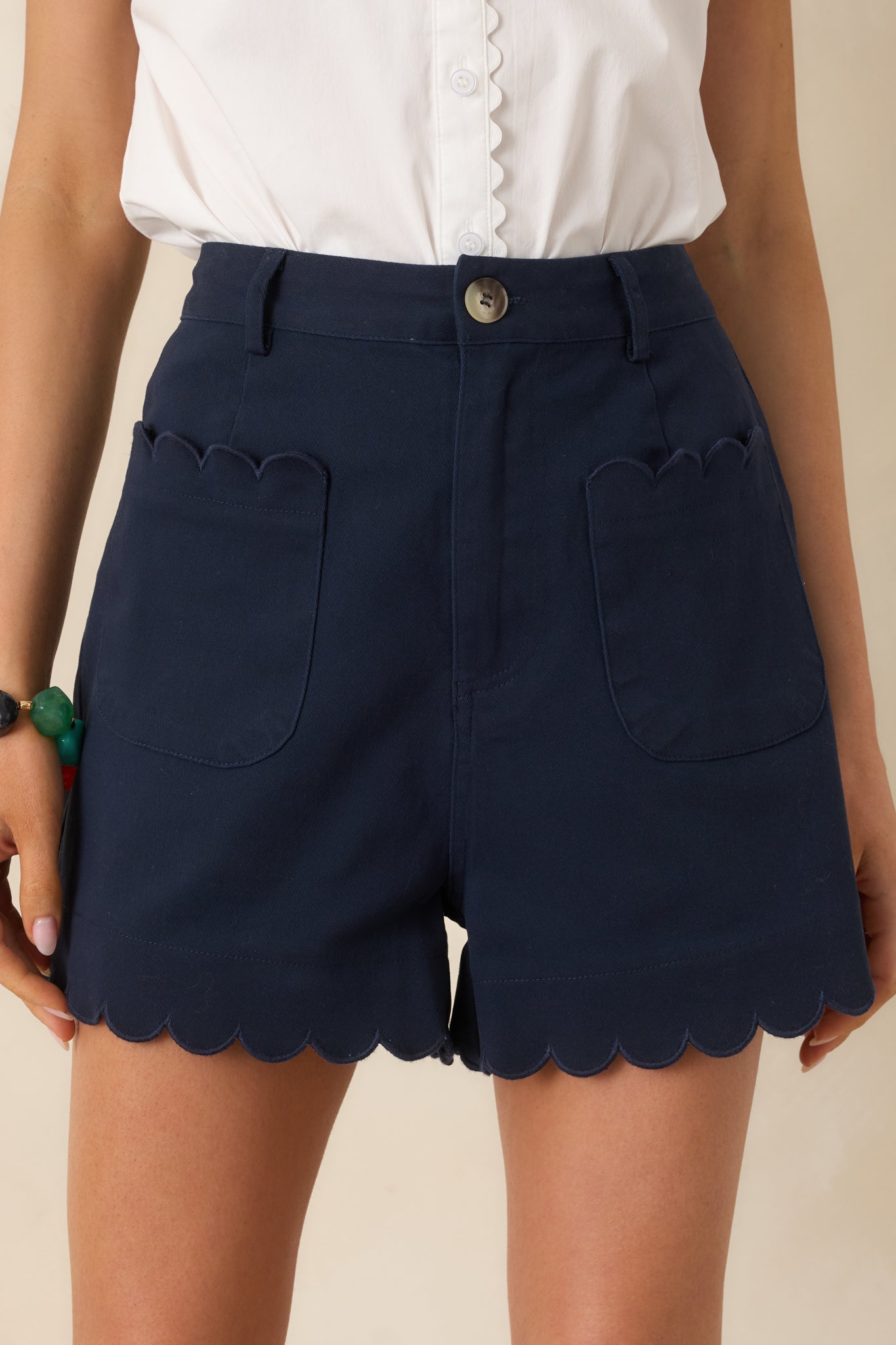 Front scalloped patch pocket detail with stitched trim.