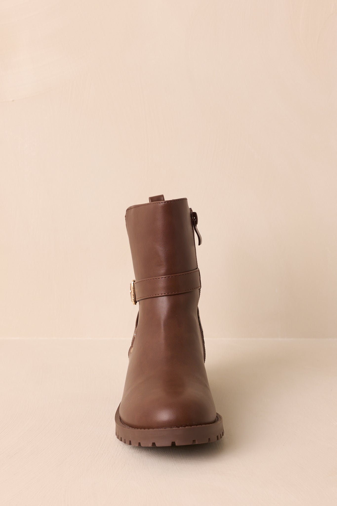 A straight-on front shot of the ankle boots capturing the rounded toe and wraparound strap.