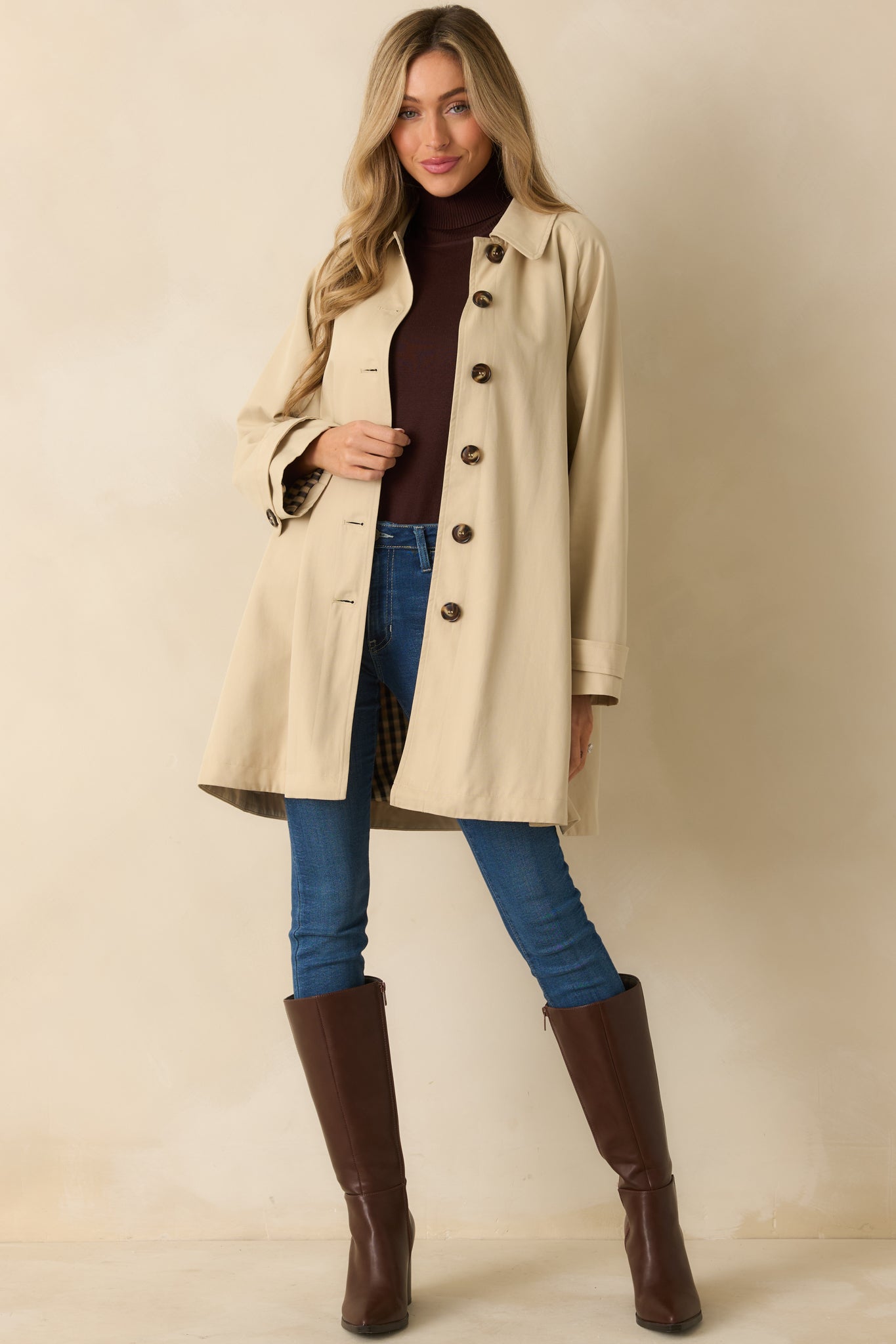 Front view of beige jacket highlighting side pockets and tailored silhouette.