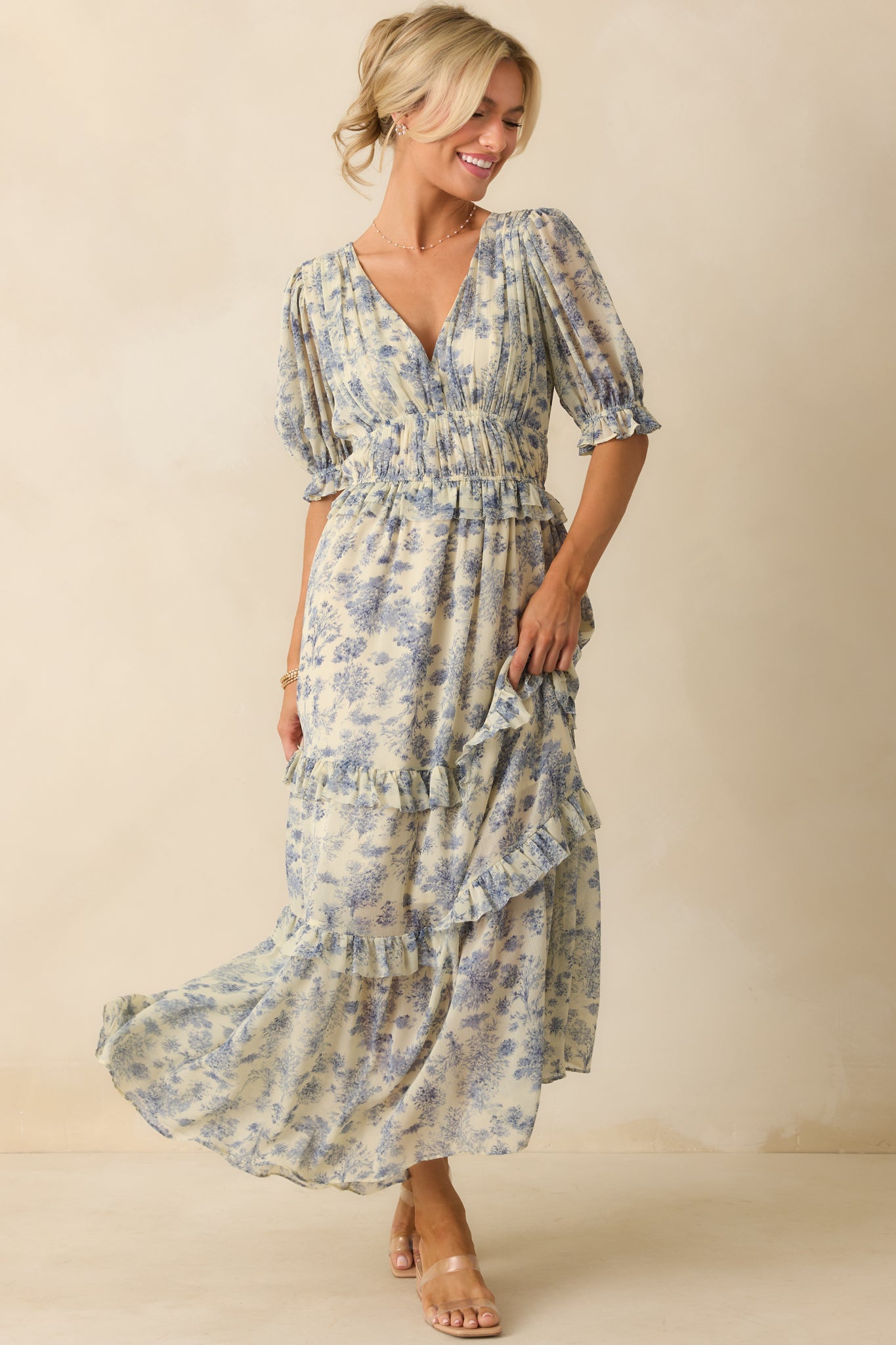 Blue floral dress displayed front-on, emphasizing the two thin elastic waistbands and cinched silhouette.