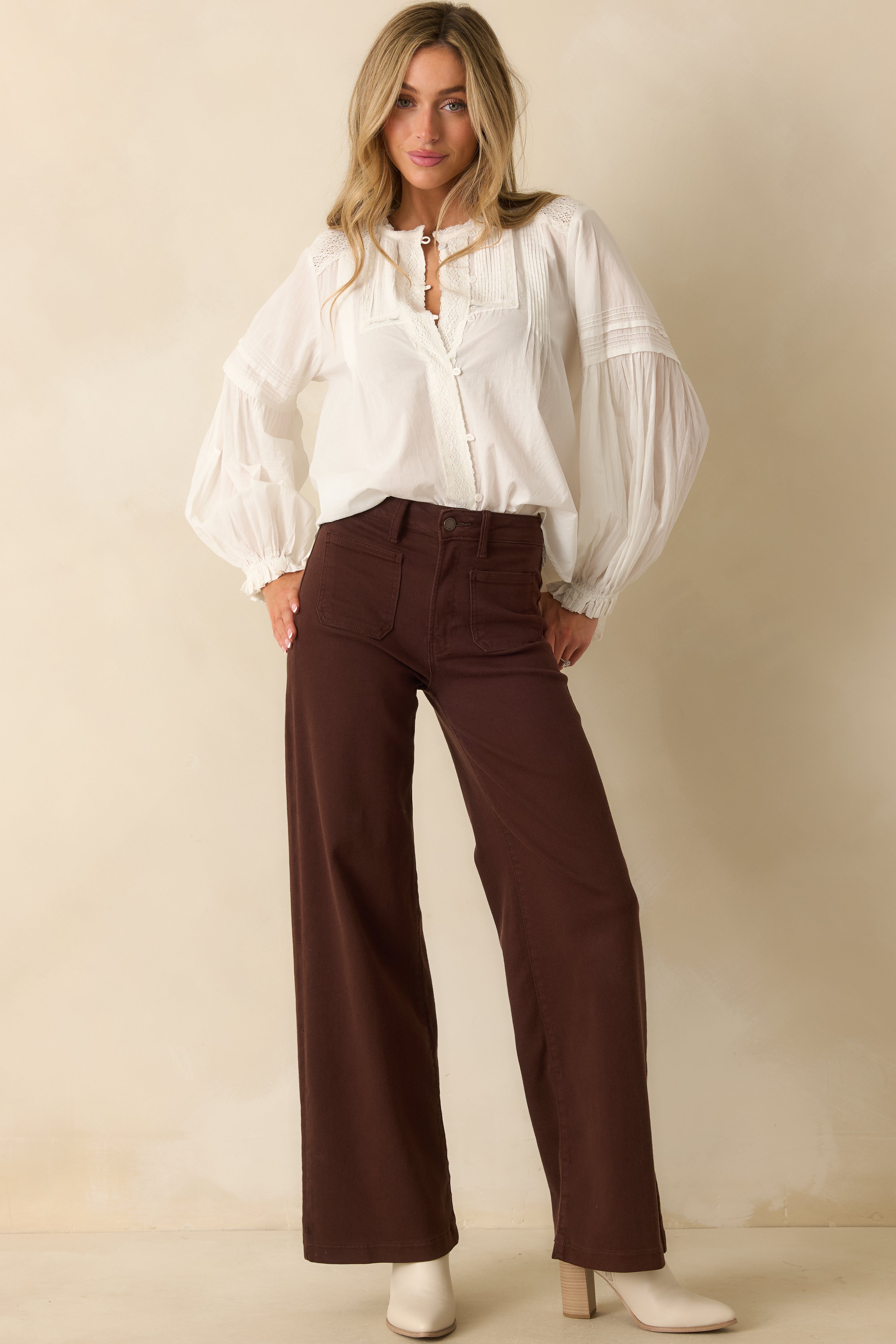 Front view of brown jeans showing the high-rise waist and straight-leg silhouette.