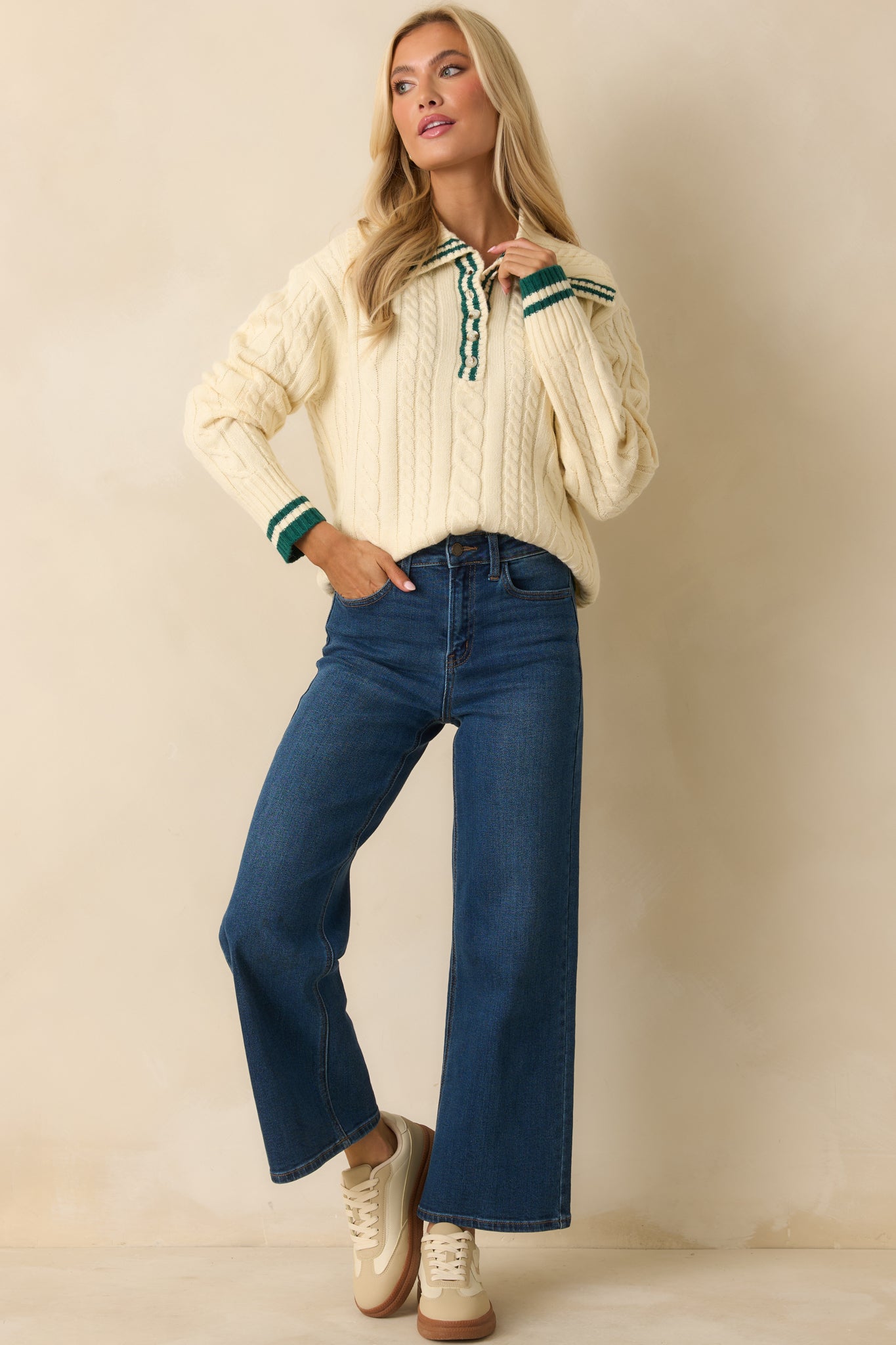 Front view of soft acrylic-poly blend sweater with cable knit texture, long sleeves, and contrast-trimmed collar.