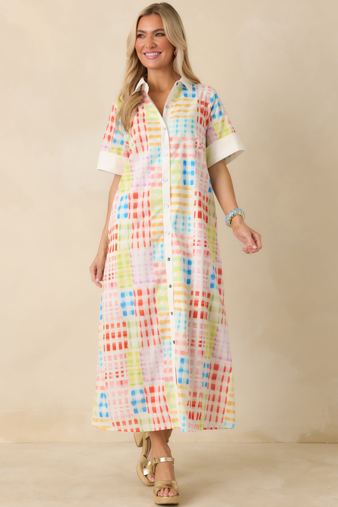 Front-facing shot showing relaxed, straight fit of check-patterned maxi dress with short cuffed sleeves.
