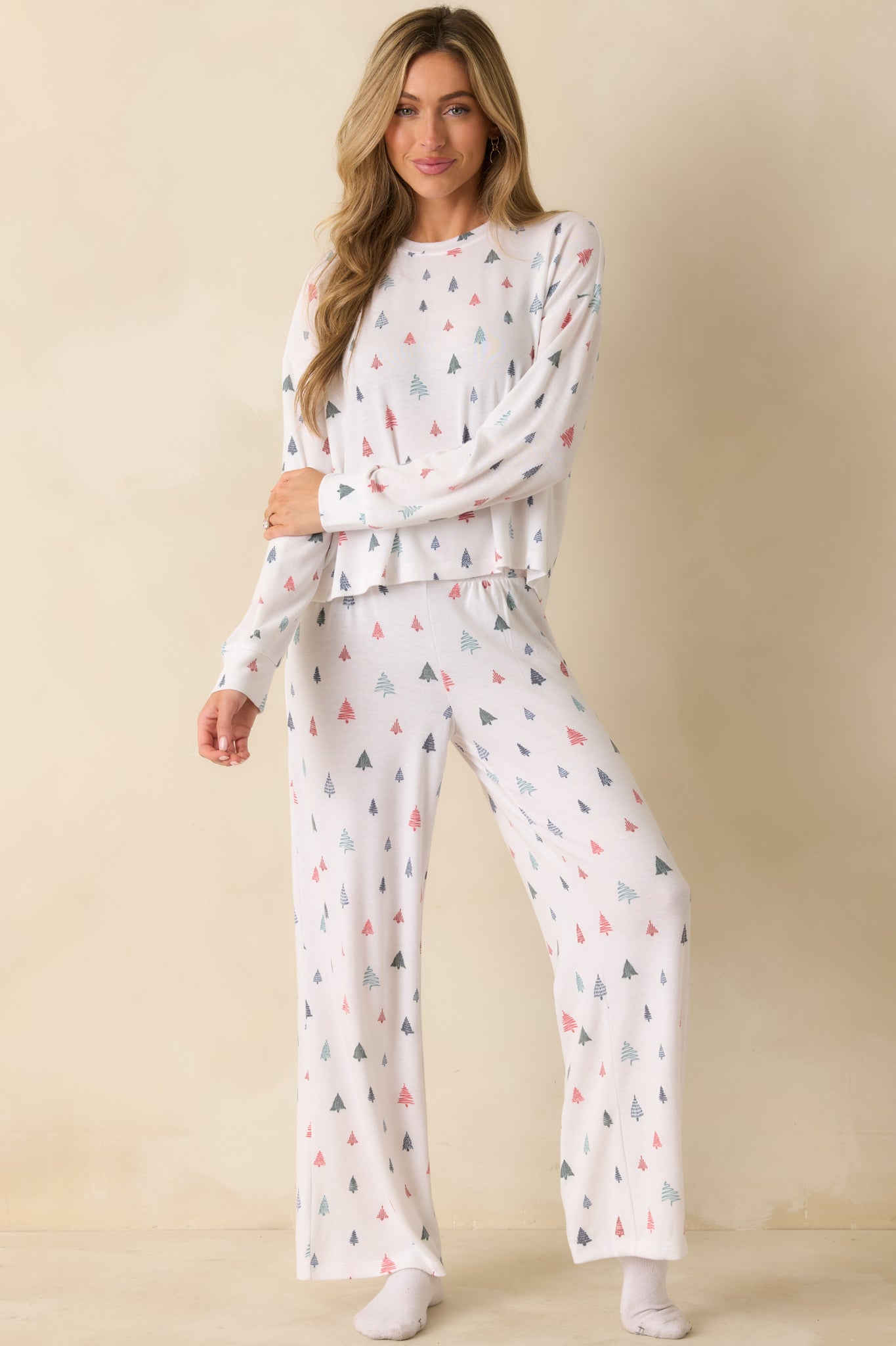Front view of cozy white pajama top featuring soft brushed knit fabric, long sleeves, and festive tree pattern.