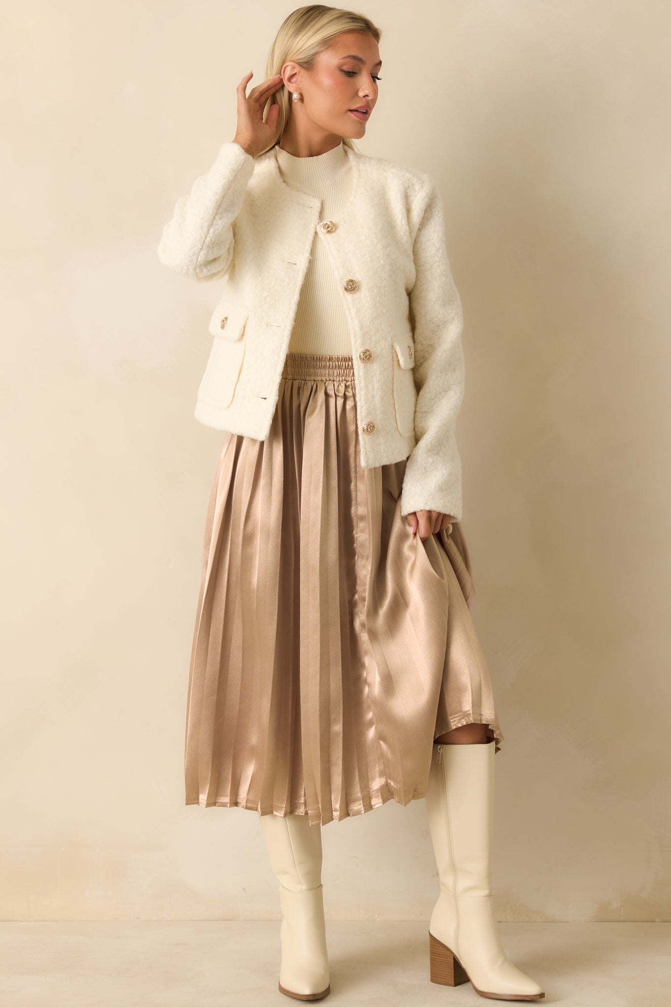 Cream bouclé jacket with round neckline and gold button closures shown fully styled from the front.