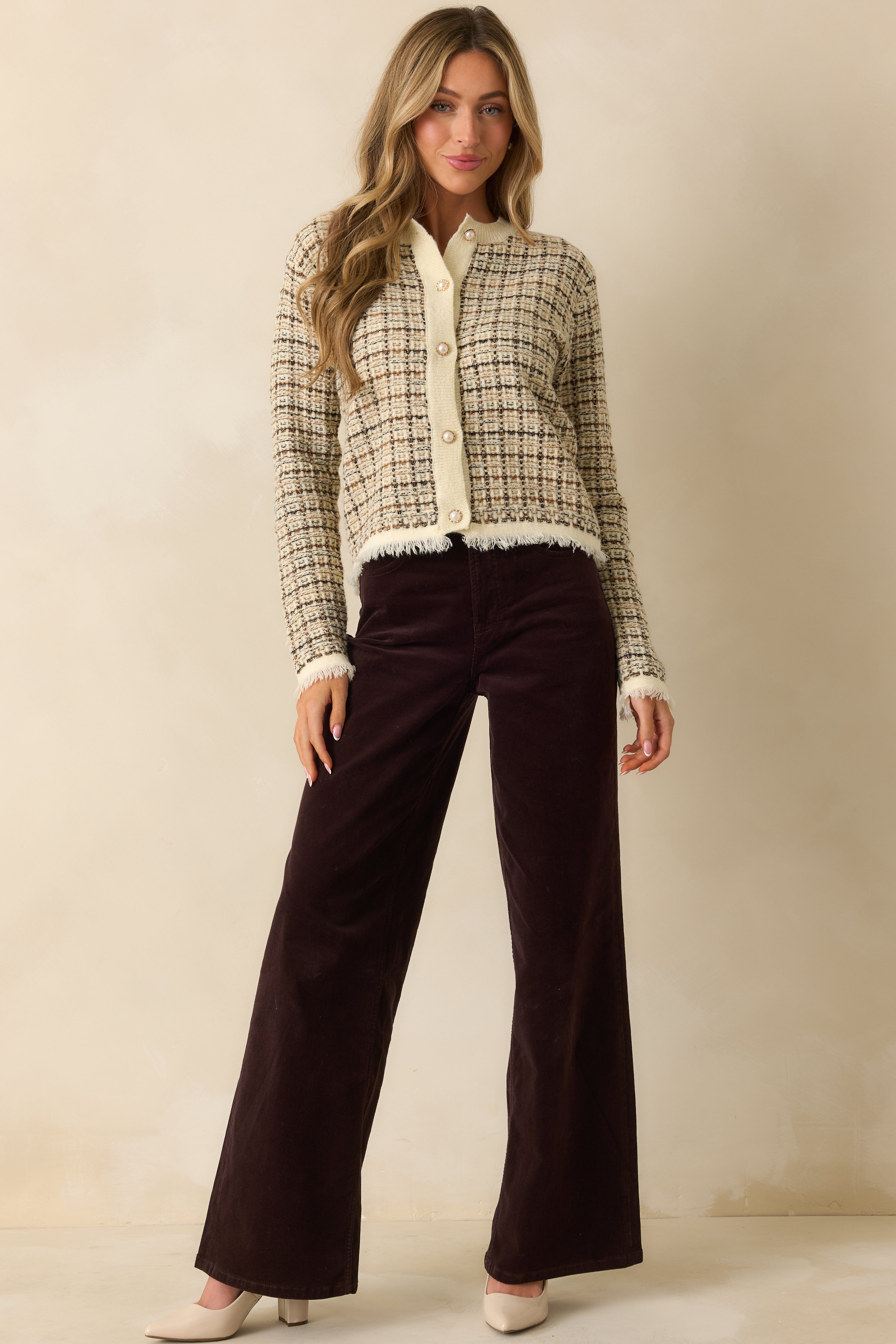 Front-facing dark brown corduroy pants highlighting wide legs and structured fit from waist to hem.
