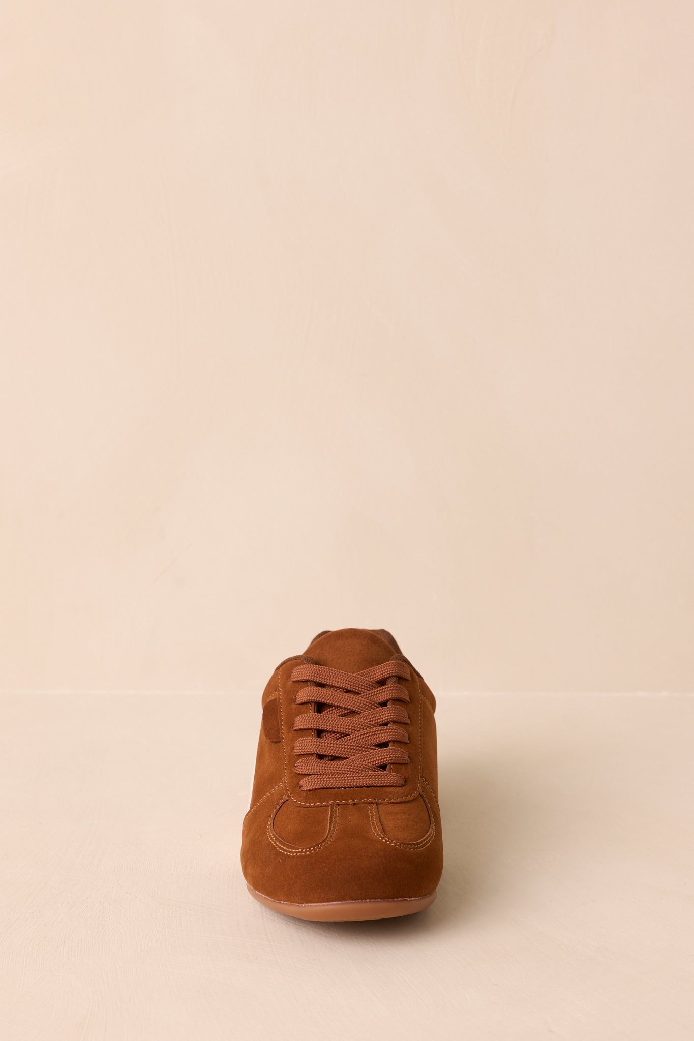 A straight-on front view displaying the lace-up design, padded collar, and sneaker shape.