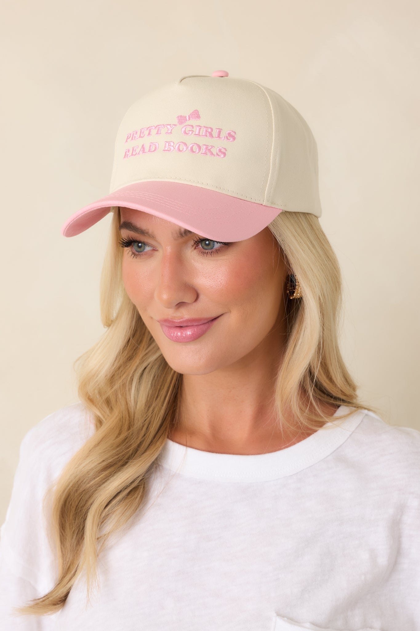 Close-cropped front view emphasizing the playful contrast embroidery and smooth cotton texture of the cap.