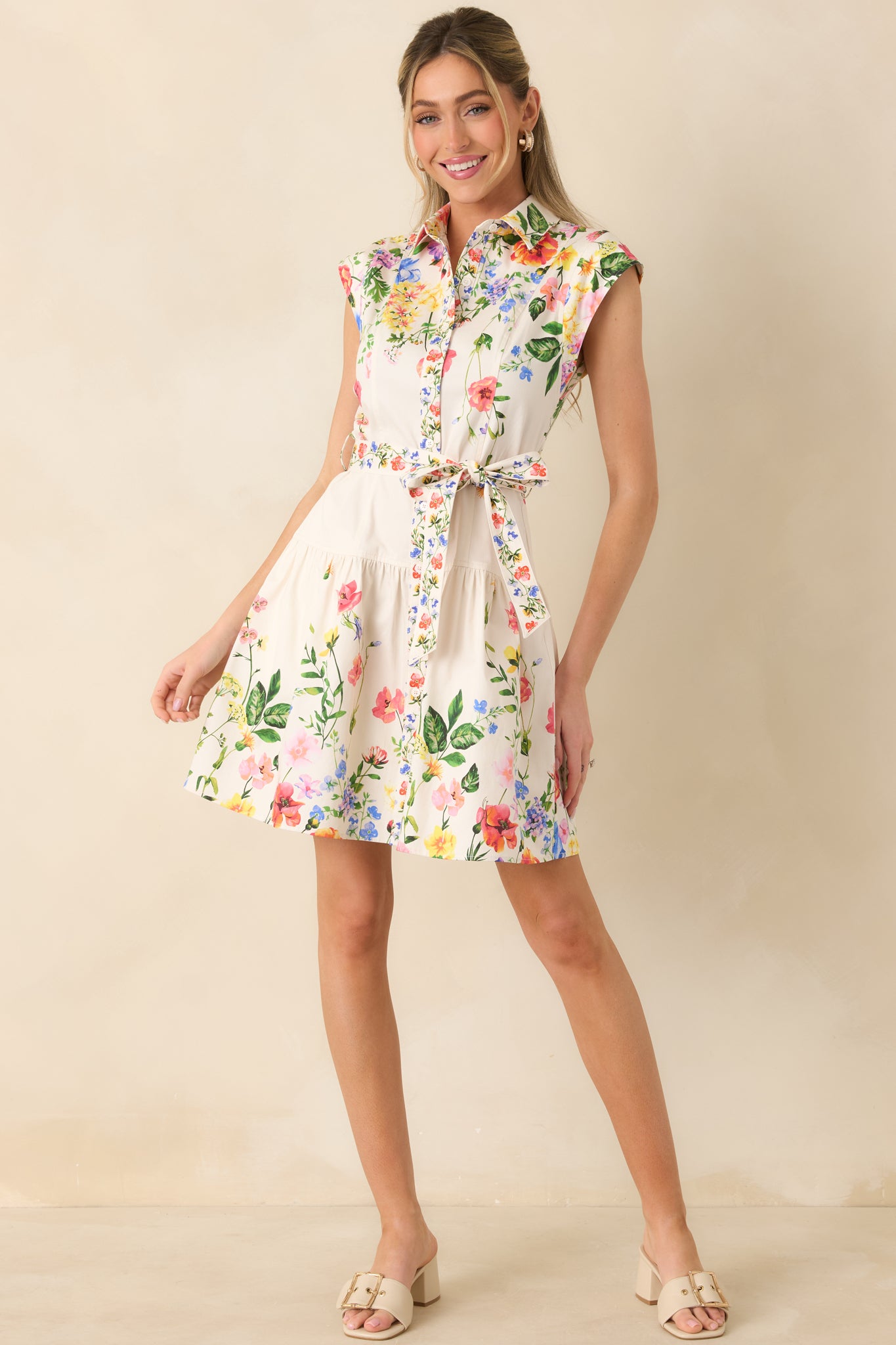 Front-facing full body image of the floral mini dress showcasing the cap sleeves and removable self-tie waist belt.