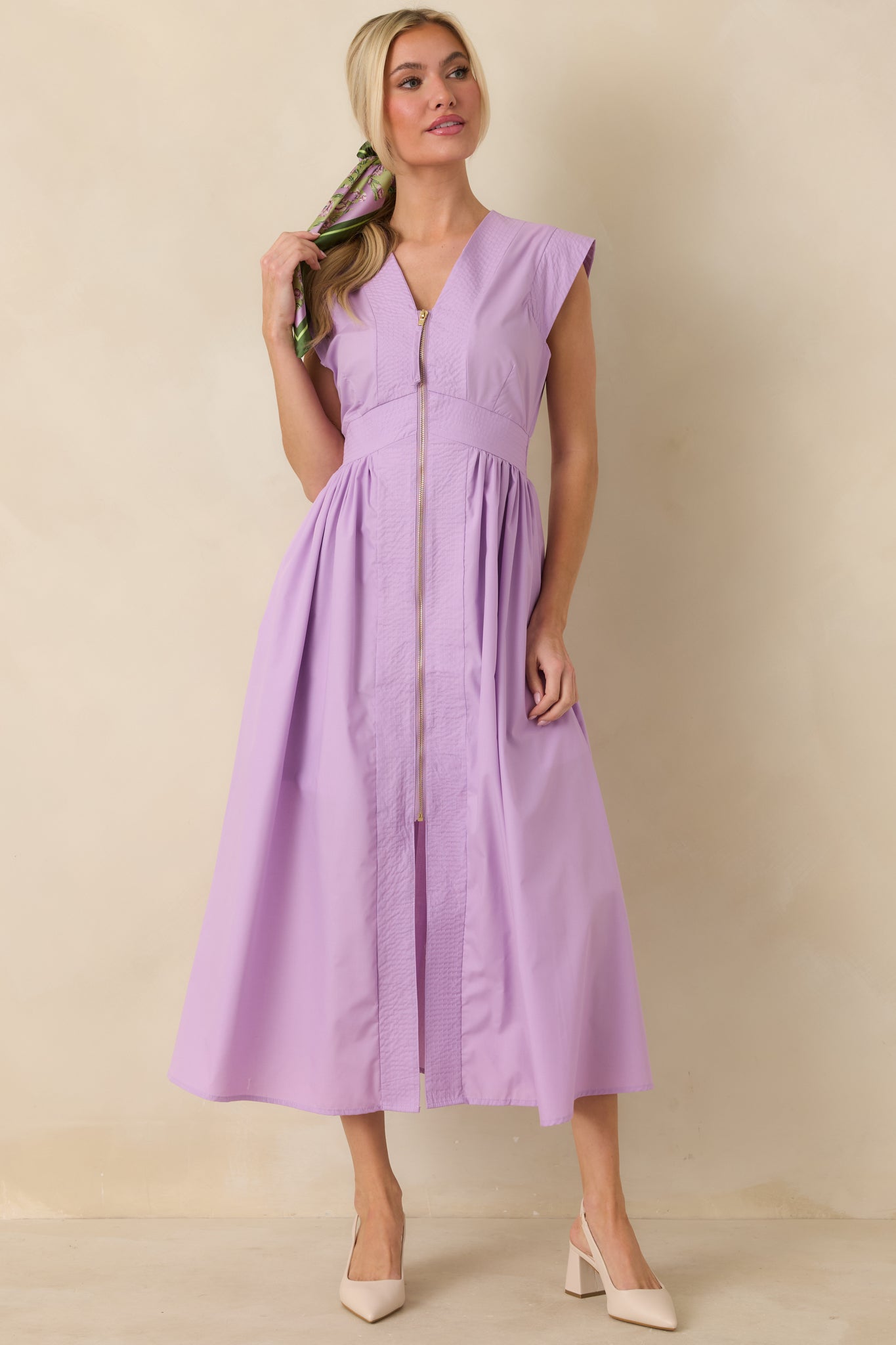 Front view focusing on the balanced silhouette created by the fitted waist, gold-tone zipper accent, and airy skirt movement.