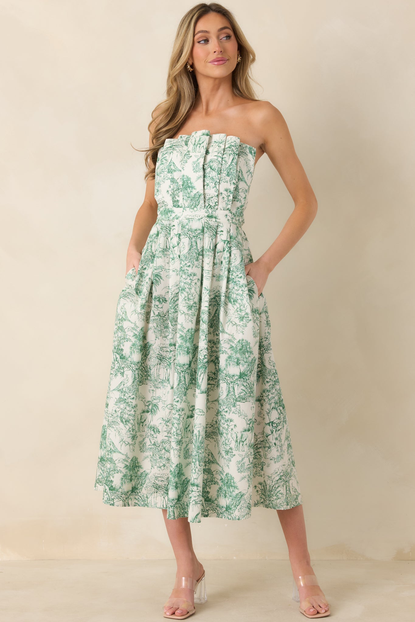 Front view of elegant green toile dress showcasing subtle pleated detailing and a relaxed midi silhouette.