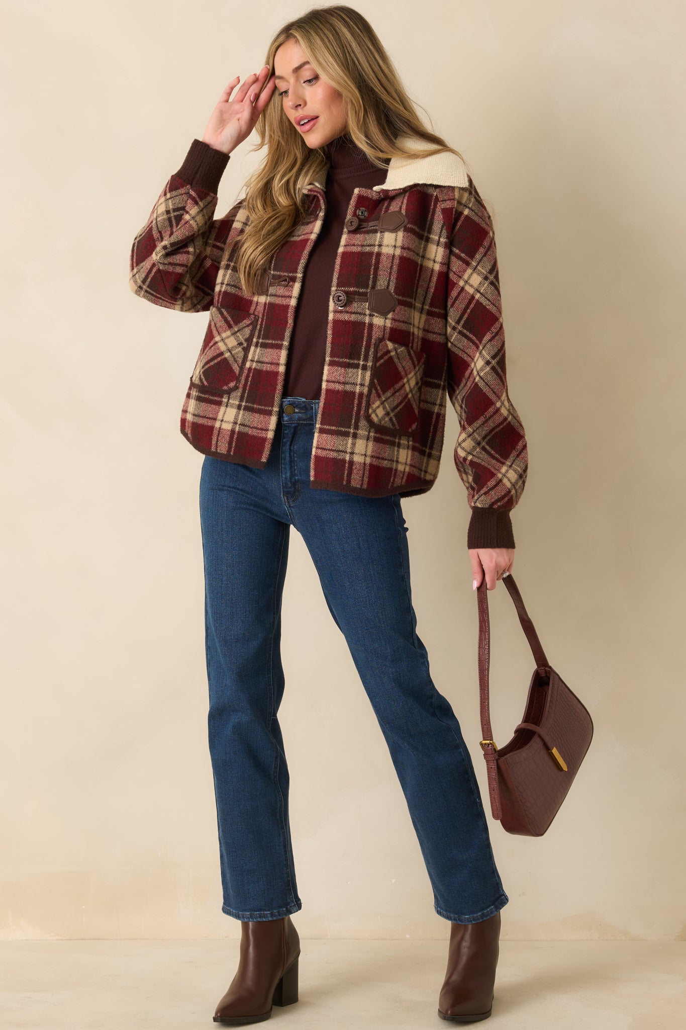 Angled front view highlighting plaid pattern, ribbed cuffs, and two functional front pockets.