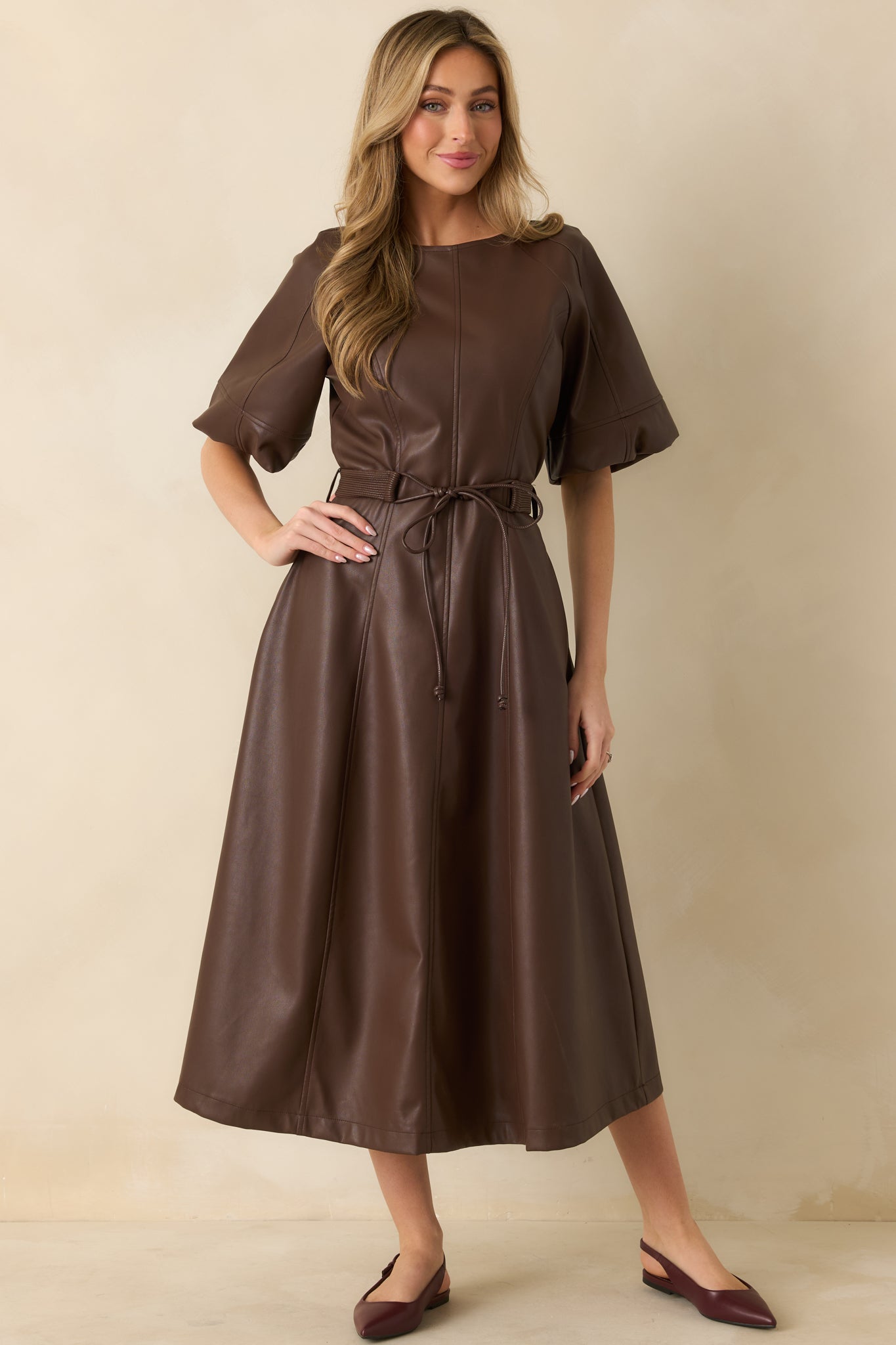 Straight-on front view highlighting the adjustable waist tie and natural flow of the midi skirt.