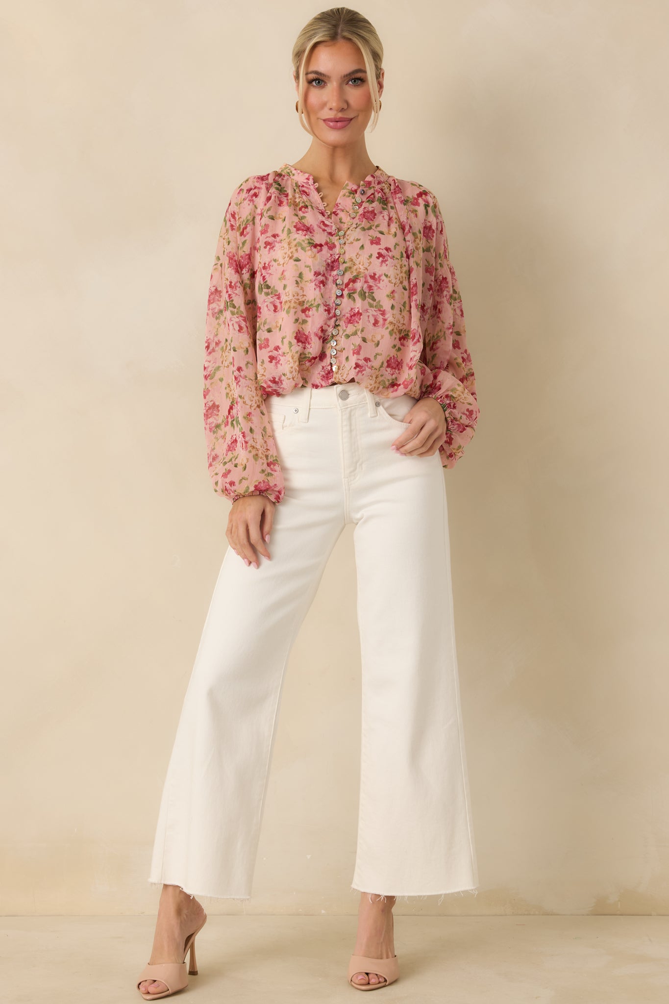 Straight-on front view highlighting the elasticized ballooned waist and cuffs and paneling on the front of the blouse.