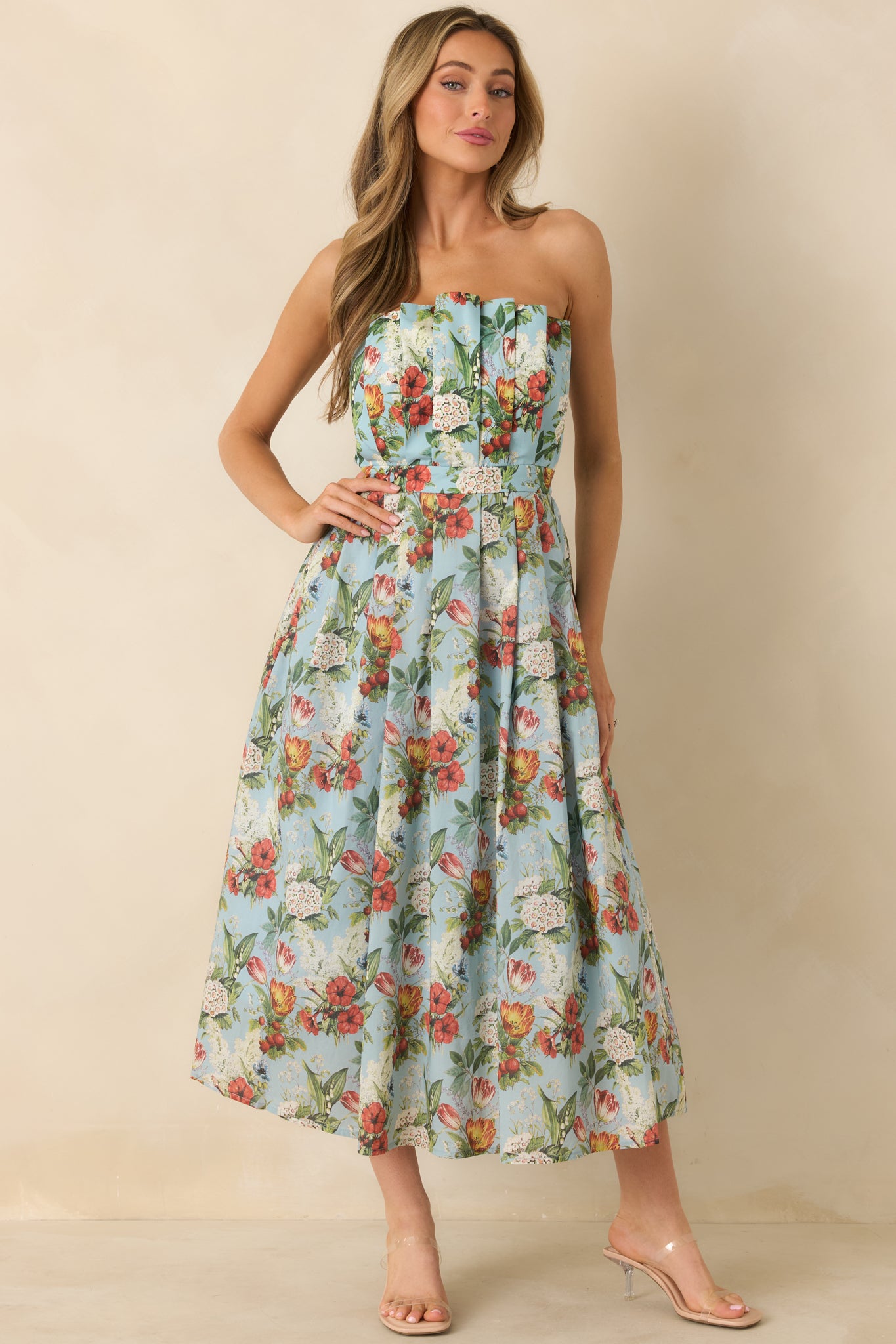 Front view highlighting the strapless neckline and structured pleated detailing throughout the dress.