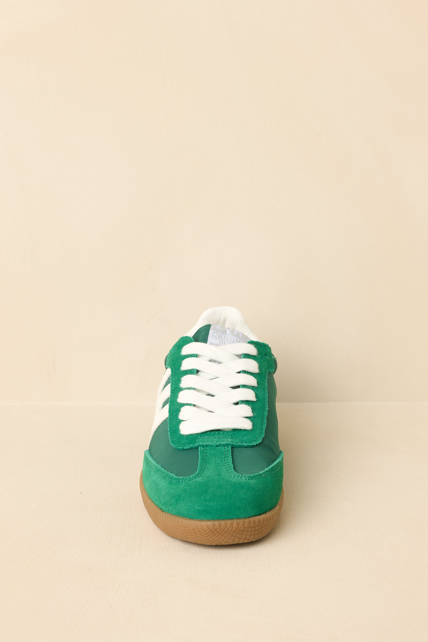 Front-facing view of the sneakers highlighting the toe shape, lace placement, and balanced material contrast.